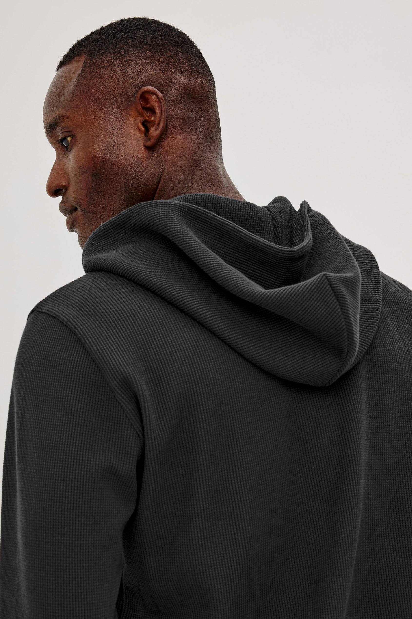 Gates Hoodie in Micro-Waffle Cotton Blend With Fixed Hood, Long Sleeves, and Relaxed Fit in Heather Grey Colorway - Upper Body Back View Featured on Model