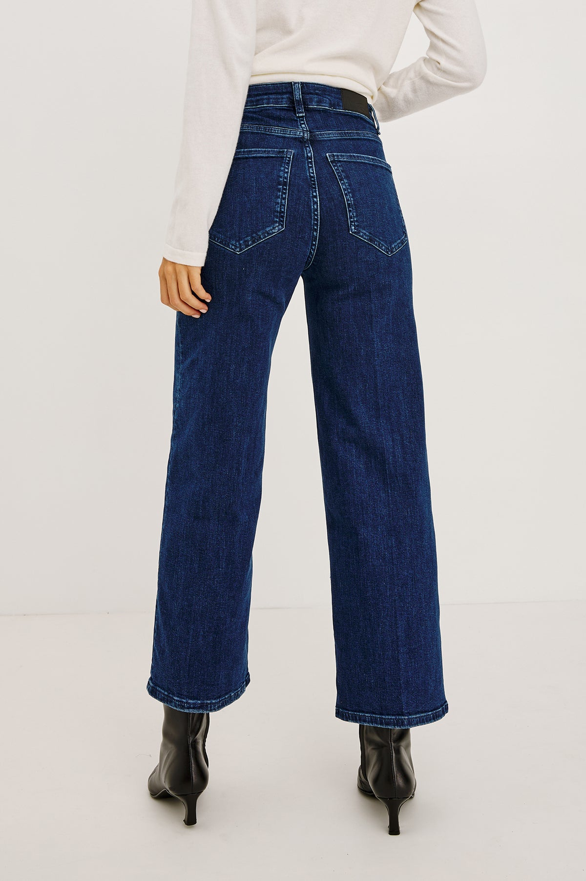 Getty Crop Wide Leg Jean in Light Stretch Denim With High-Rise High-Waisted Fit, Button Fly, and 5-Pockets in After Midnight Colorway - Upper Body Back View Featured on Model.