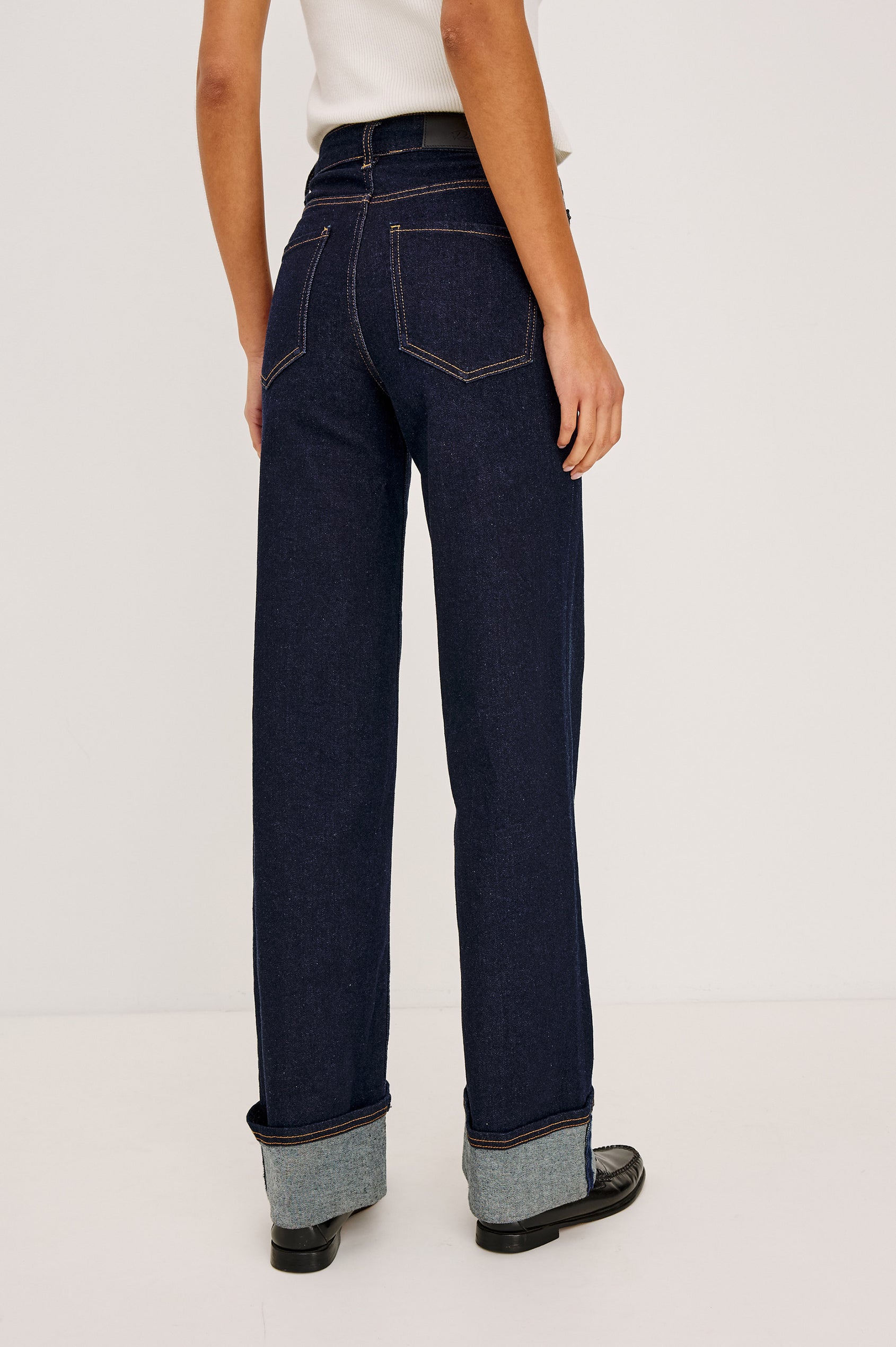 Getty Wide Leg Jean in Light Stretch Denim With High-Rise High-Waisted Fit, Button Fly, and 5-Pockets in Midnight Blues Cuffed Colorway - Lower Body Back View Featured on Model
