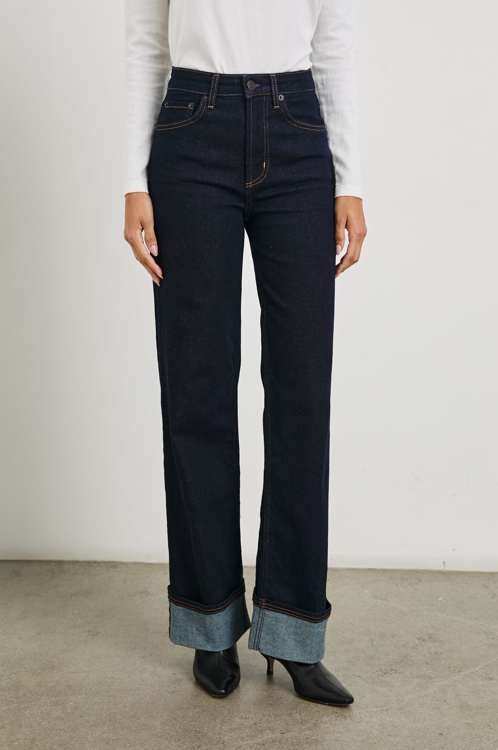 Getty Wide Leg Denim Pants with Cuffed Hems, Belt Loops, Two Front Pockets and Two Back Patch Pockets in Midnight Blues Cuffed Colorway - Front View Featured on Model