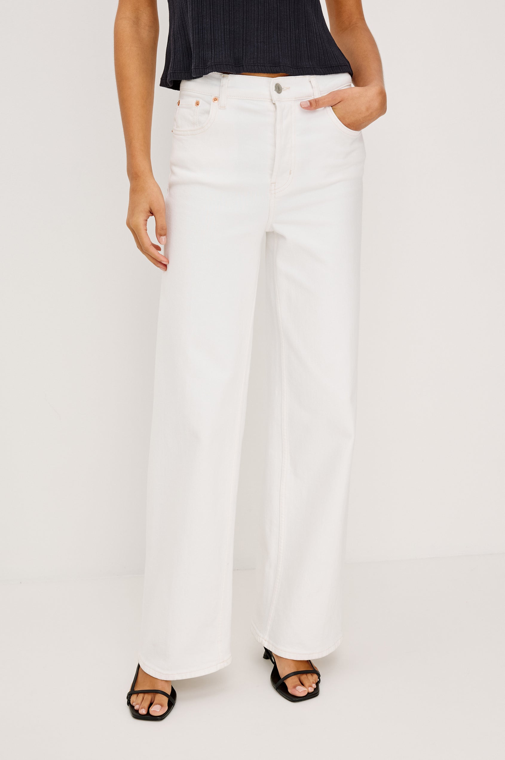 Getty Wide Leg Jean in Light Stretch Denim With High-Rise High-Waisted Fit, Button Fly, and 5-Pocket Styling in Vintage Ecru Colorway - Lower Body Front View Featured on Model