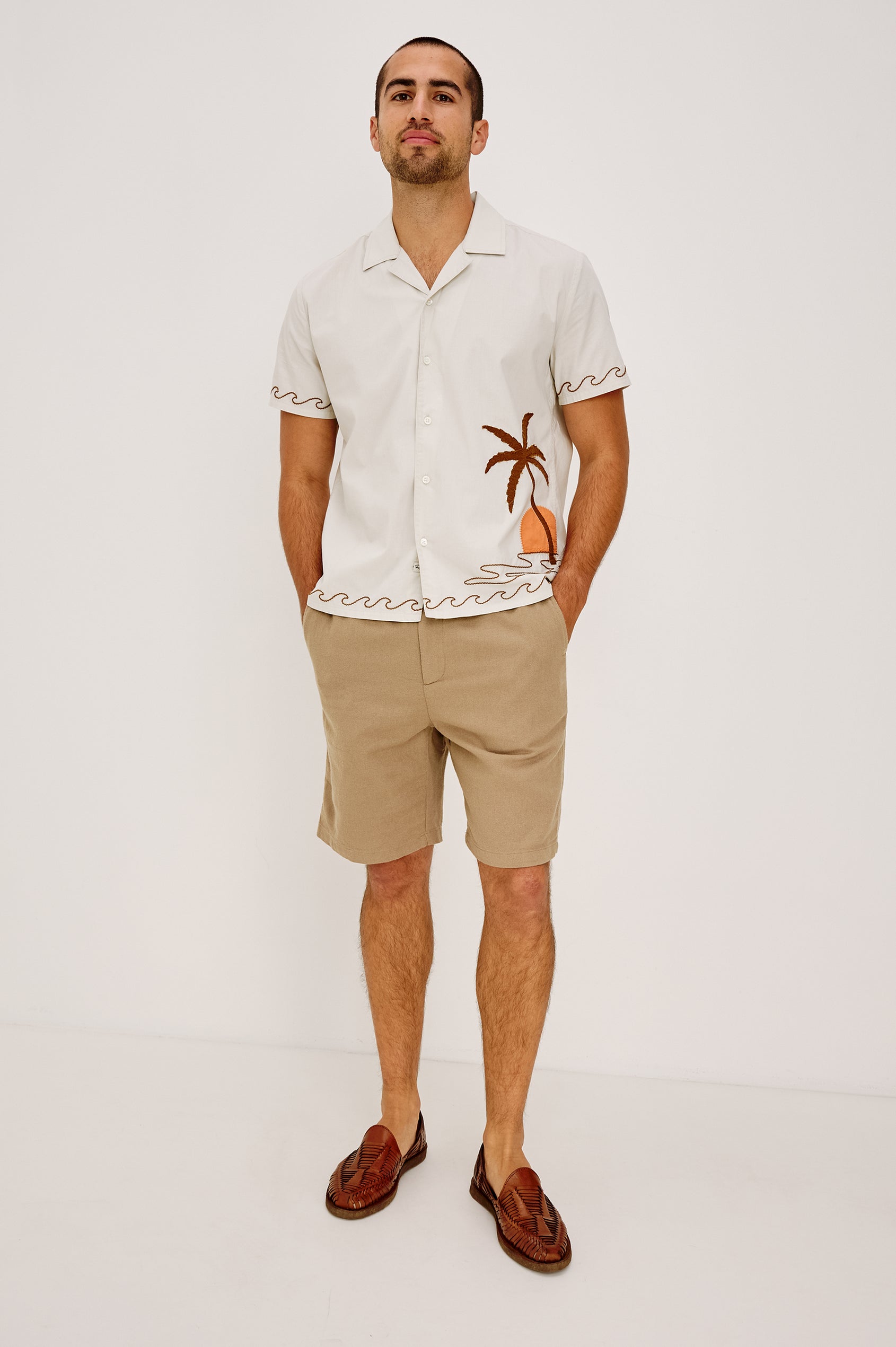 Gibson Button-Up Shirt in Stretch Linen Blend With Short Sleeves, Notched Collar, and Palm Tree Embroidery in Natural Sunset Colorway - Full Body Front View Featured on Model