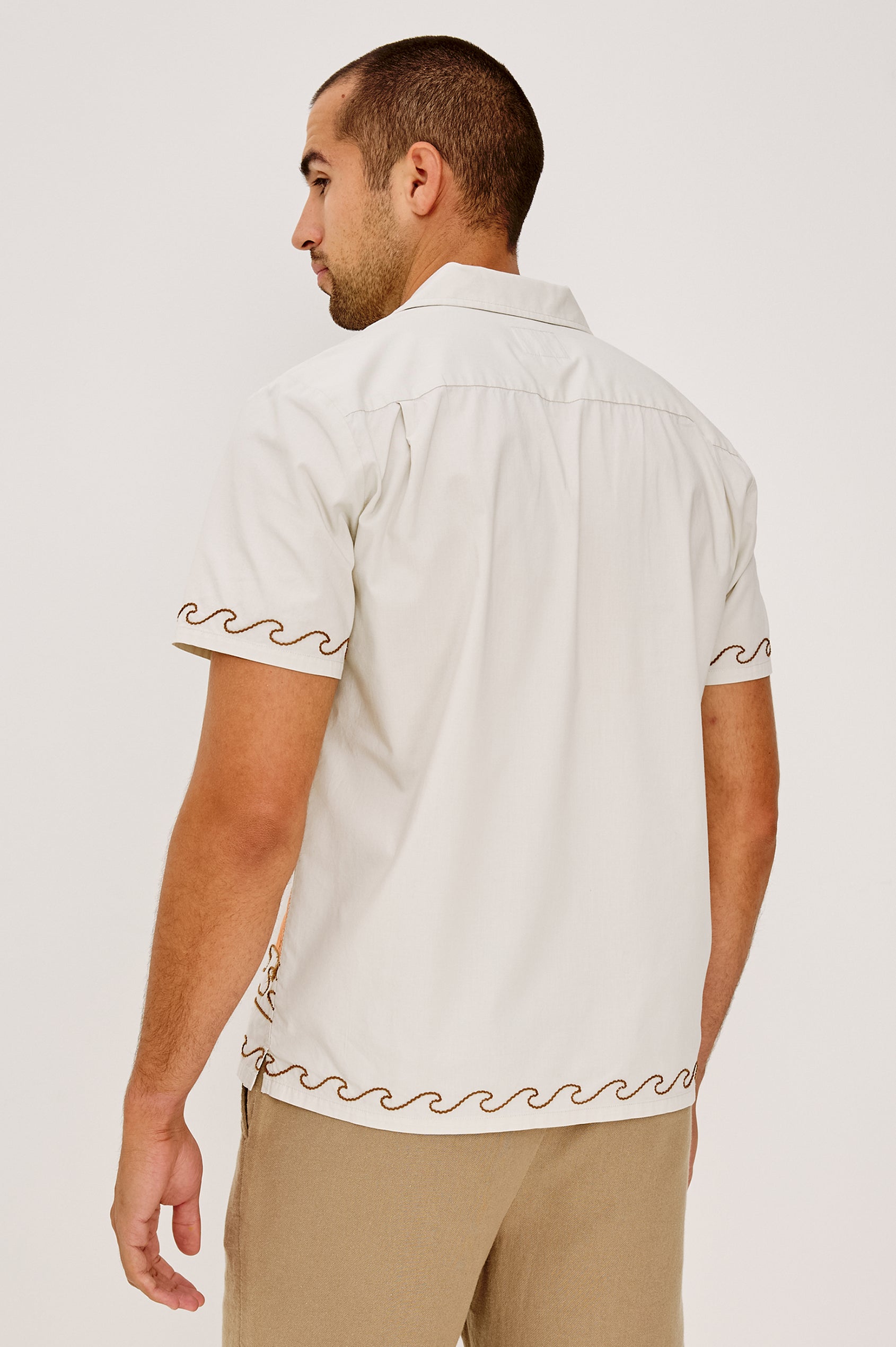 Gibson Button-Up Shirt in Stretch Linen Blend With Short Sleeves, Notched Collar, and Palm Tree Embroidery in Natural Sunset Colorway - Upper Body Back View Featured on Model
