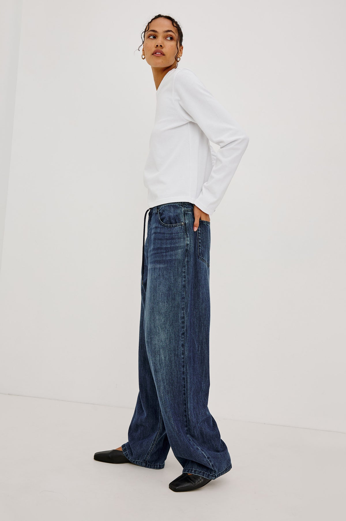 Long Sleeve Girlfriend Tee in Midweight Pleated Jersey in Slightly Boxy Cropped Fit With Crew Neckline in White Colorway - Full Body Front View Featured on Model.