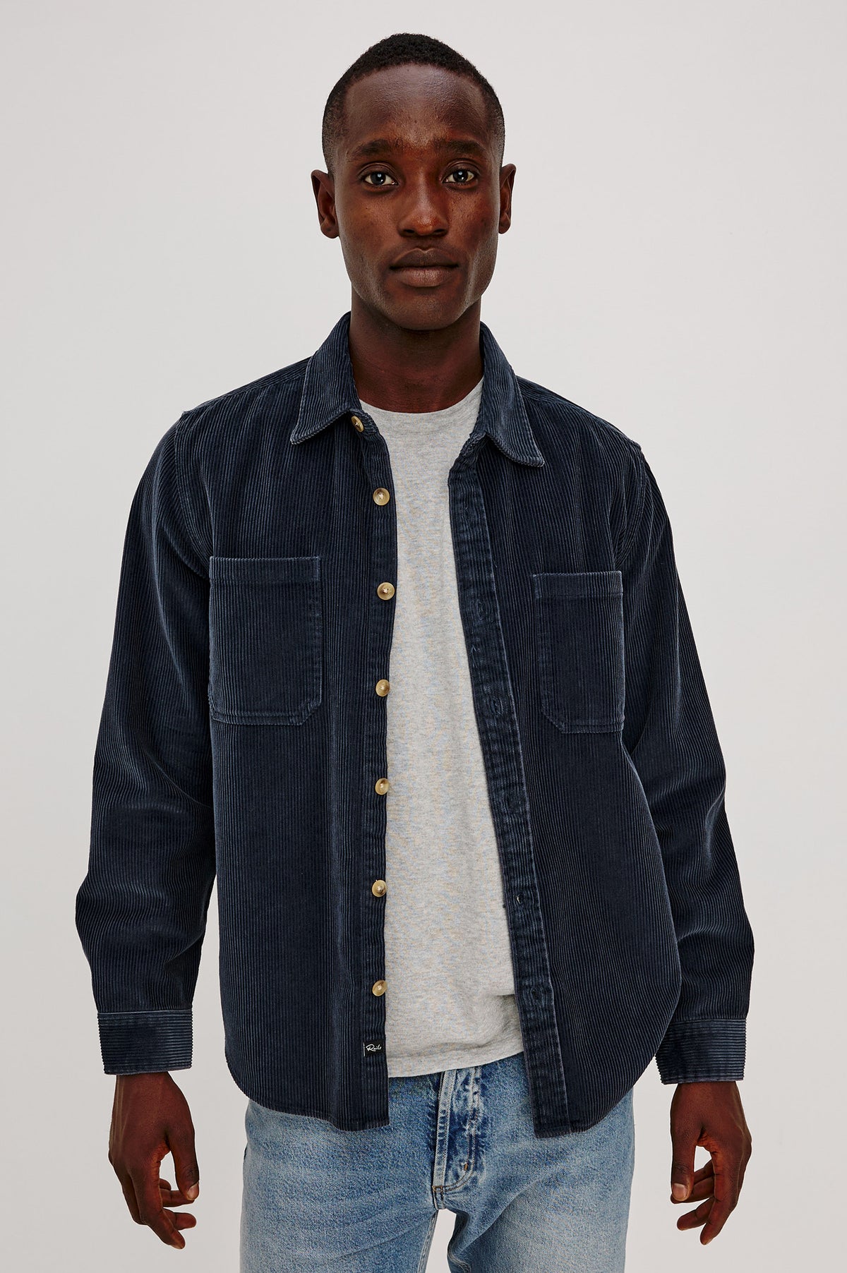 Graham Overshirt in Corduroy With Vintage Wash, Relaxed Fit, Collar, Chest Patch Pocket, and Front Buttons in Midnight Blue Colorway - Upper Body Front View Featured on Model