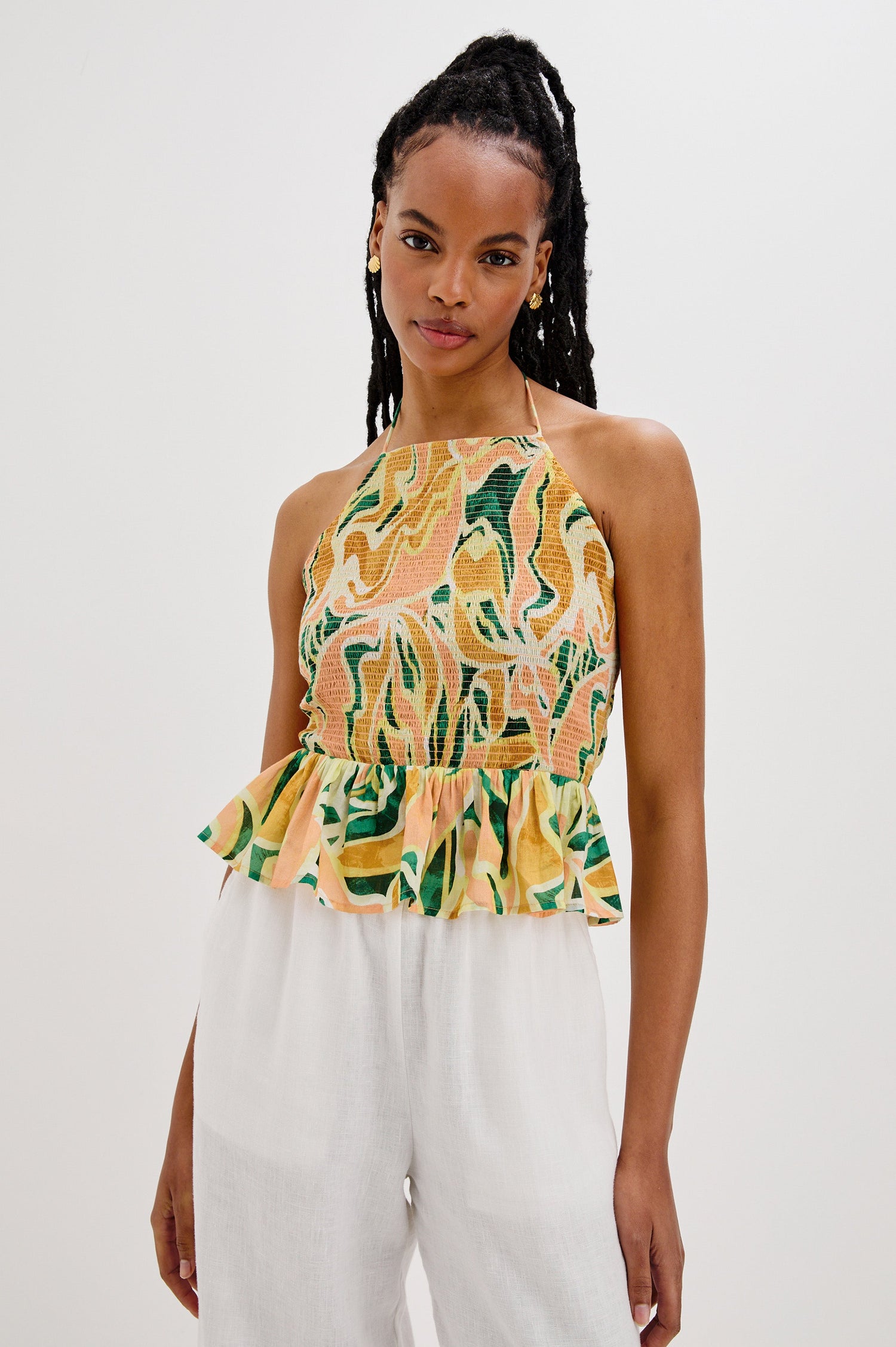 Gwendolyn Square Neck Halter Top with Smocked Body and a Ruffled Peplum Hem in Tulum Colorway. Front View Shown on Model. 