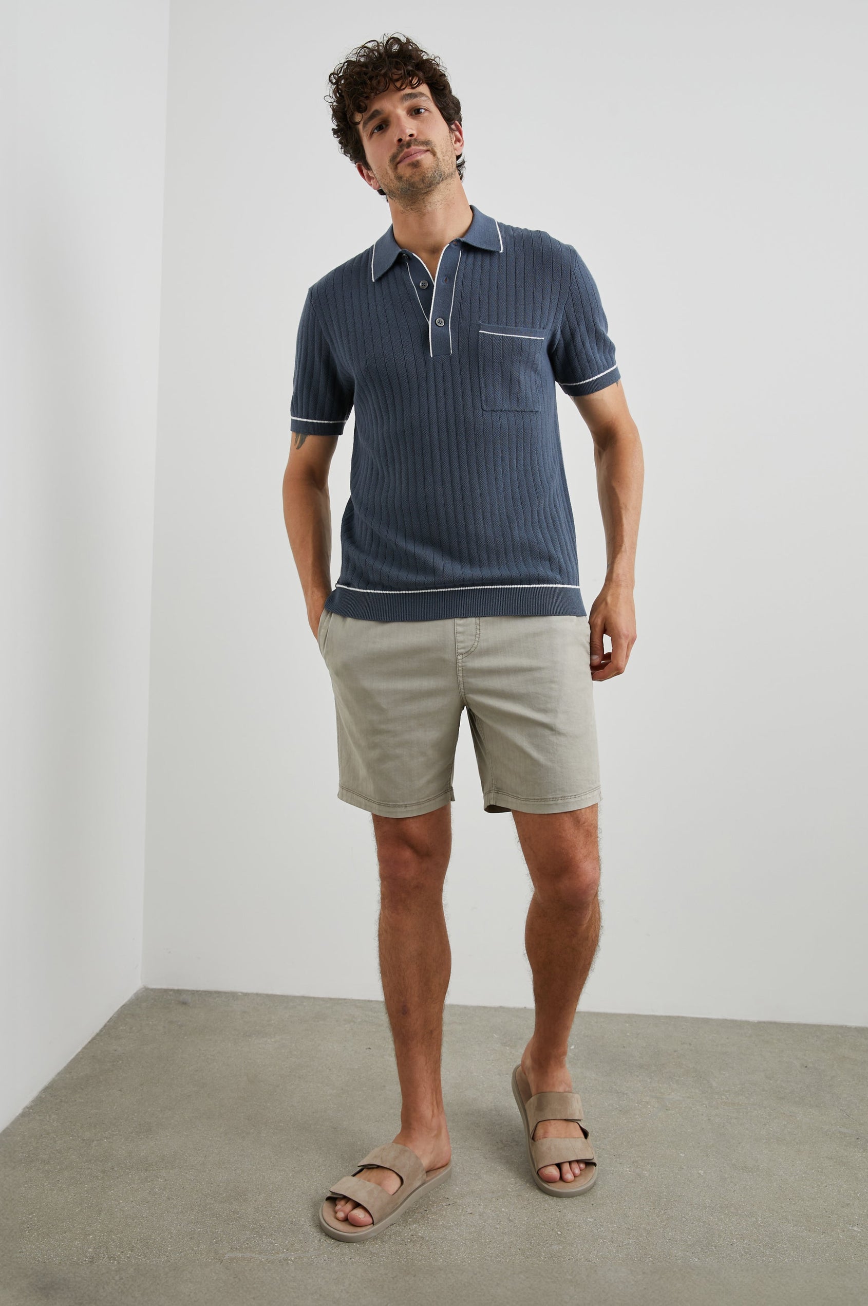 Hardy Short-Sleeve Ribbed Polo Shirt with a Chest Patch Pocket and a Three-Button Placket in Faded Navy Colorway, with White Trim - Front Full Body View Featured on Model 