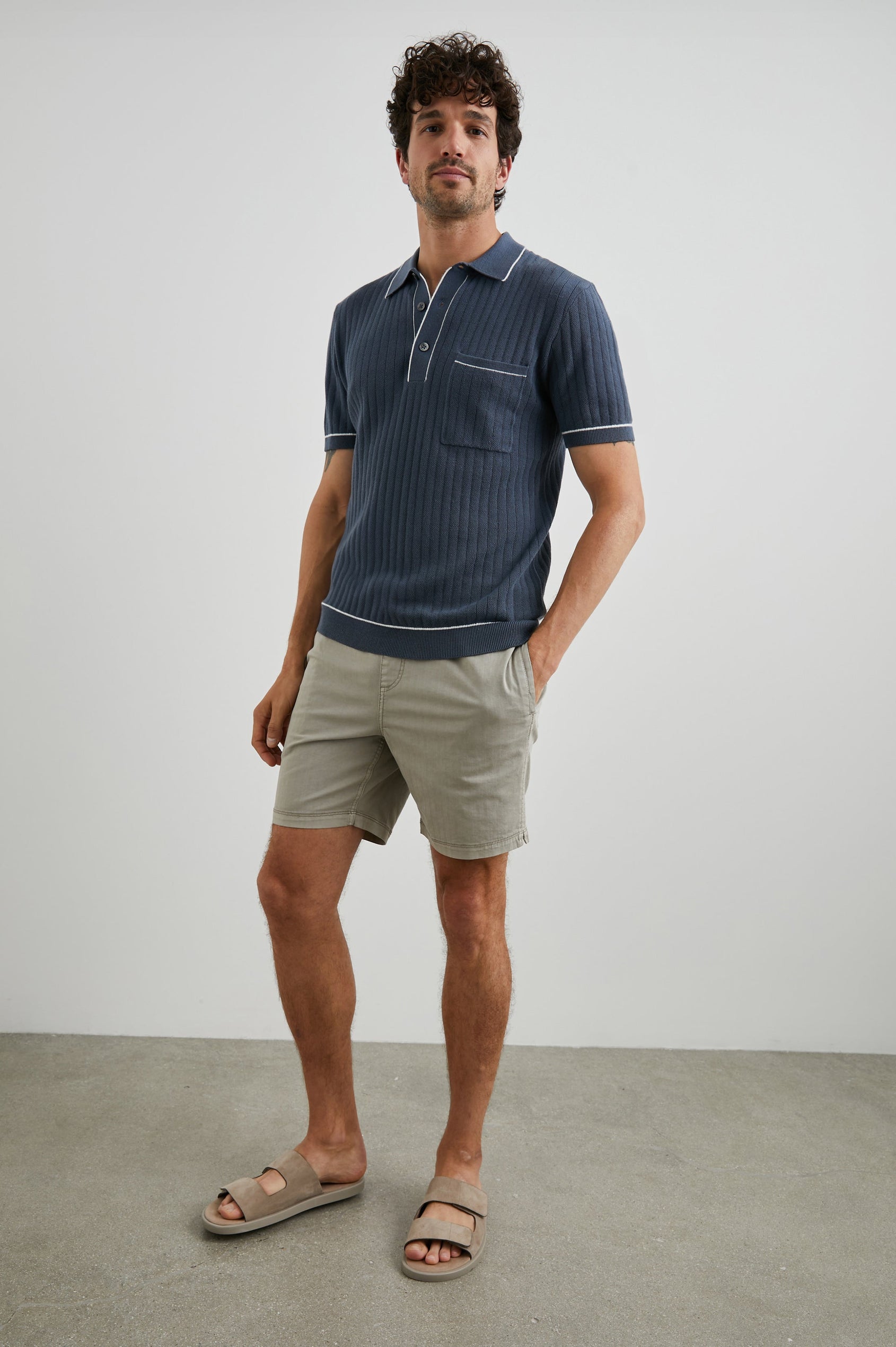 Hardy Short-Sleeve Ribbed Polo Shirt with a Chest Patch Pocket and a Three-Button Placket in Faded Navy Colorway, with White Trim - Front Full Body View Featured on Model 
