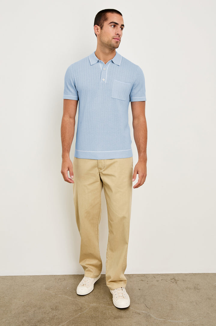 Hardy short sleeve cotton rib polo with chest pocket, two button placket and contrast stitching in Light Blue Melange - full body front view on model