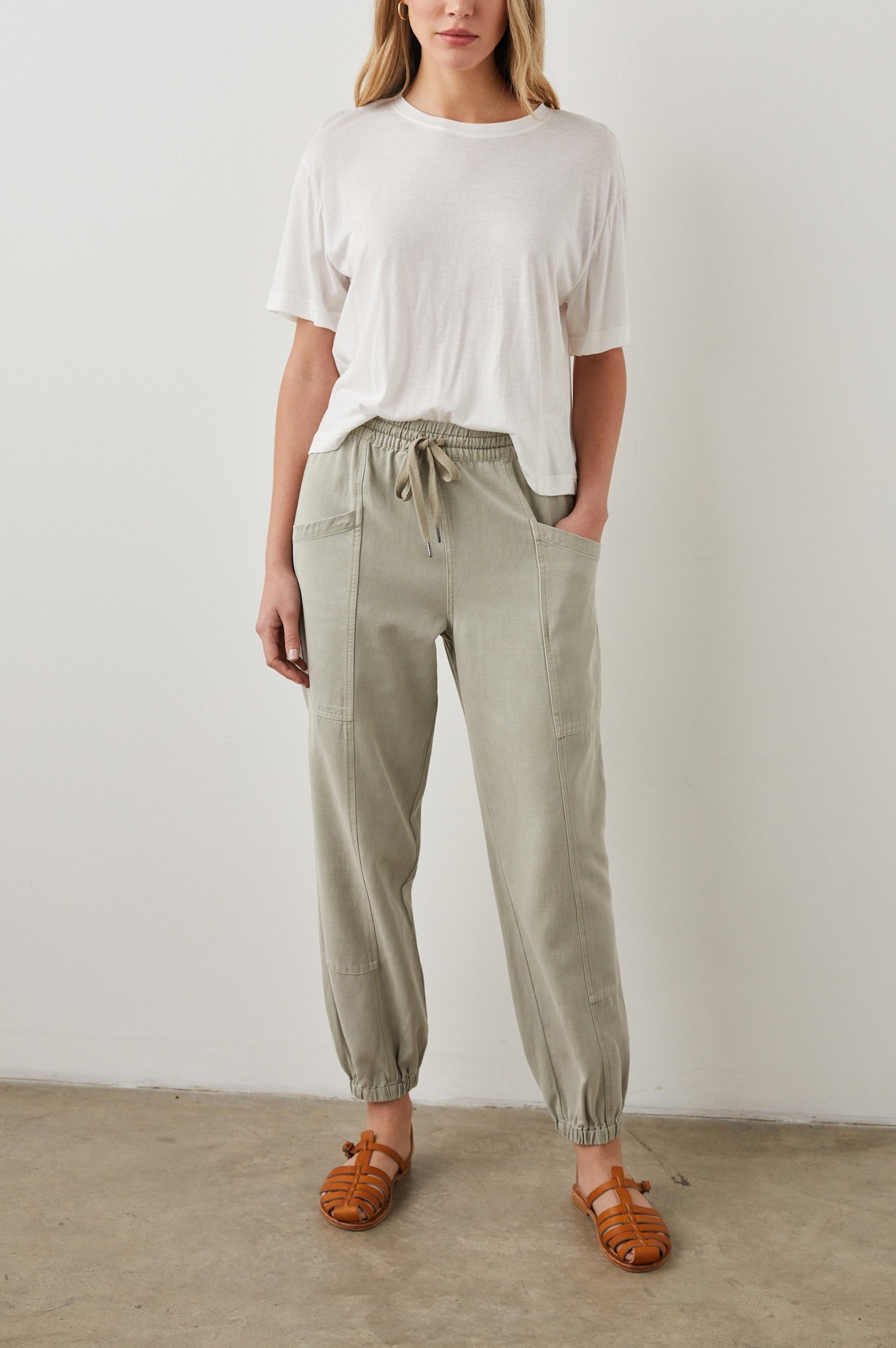 Haven Pants with a Drawstring Waist, Front Seams, Elasticized Hems, Two Front Pockets and Two Back Welt Pockets in Sage Colorway - Front Full Body View Featured on Model 