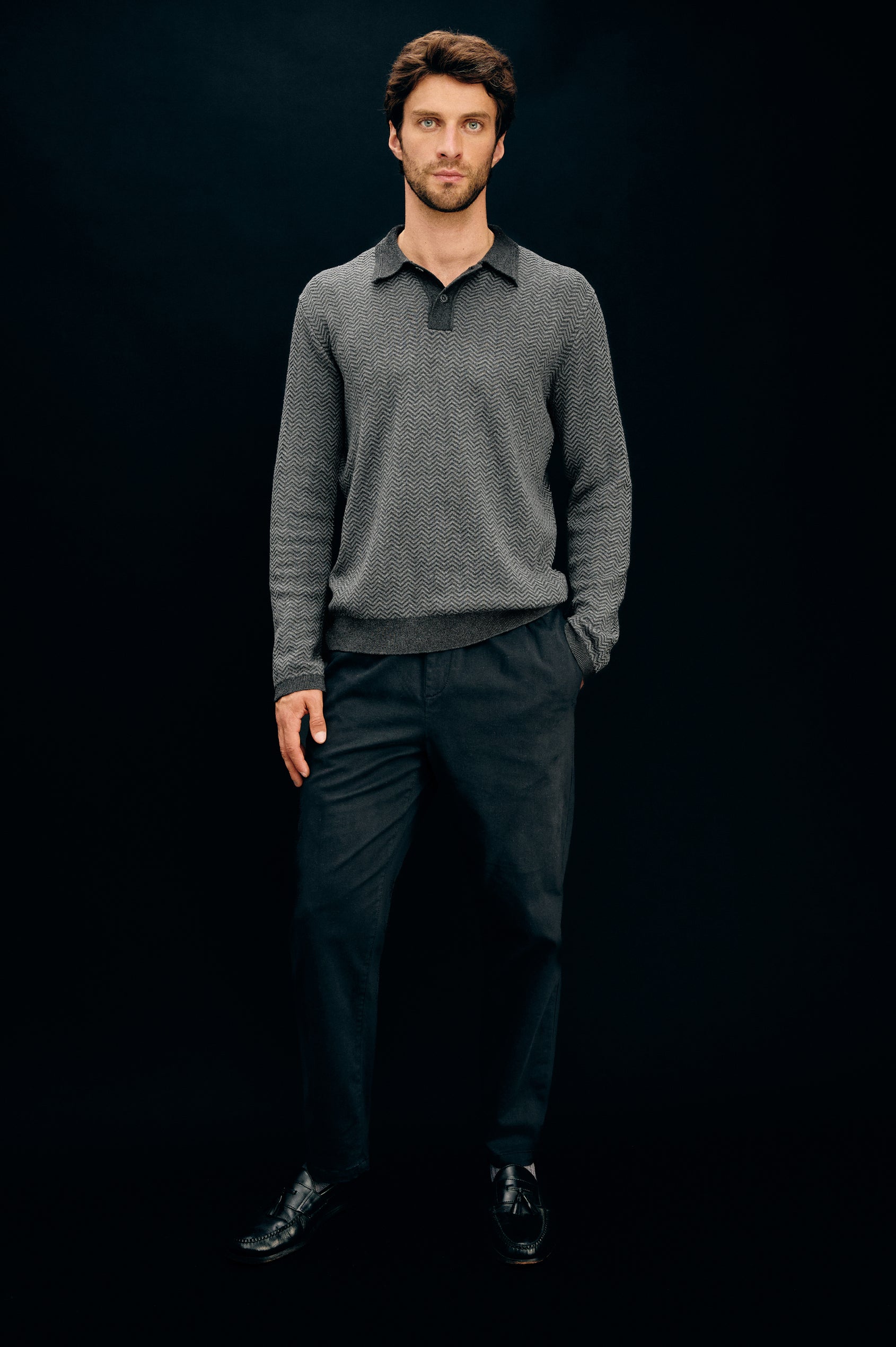 Herrington Long-Sleeve Collared Sweater with a Two Button Placket and a Herringbone Jacquard in Charcoal Herringbone Melange Colorway. Front Full Body View Featured on Model.