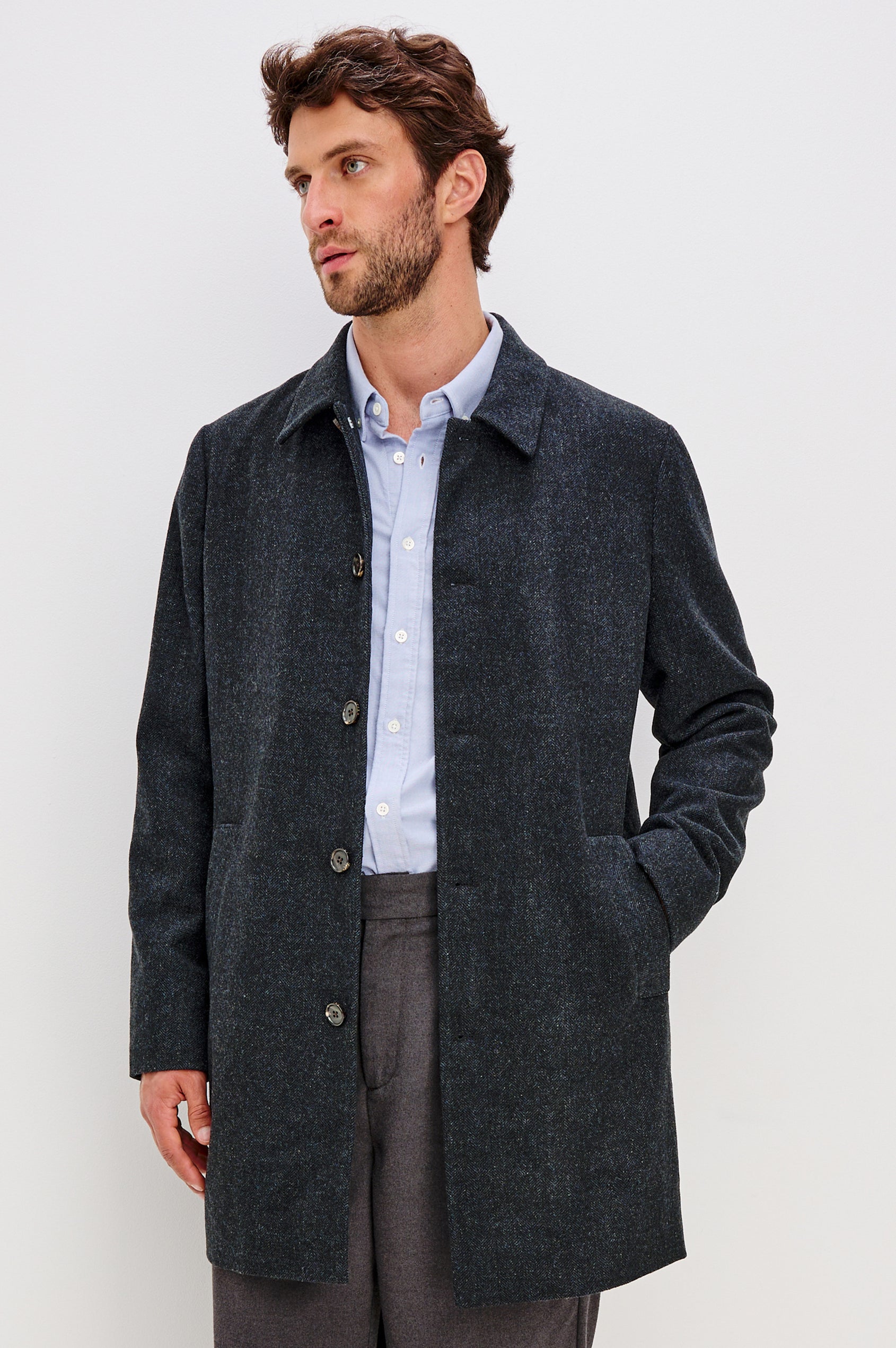 Hockney is a traditional top coat, wool-blended and lined with welt pockets, interior pockets on both sides (invisible zipper and welt), and a back vent, in Celestial Tweed Color. Front view featured on model.