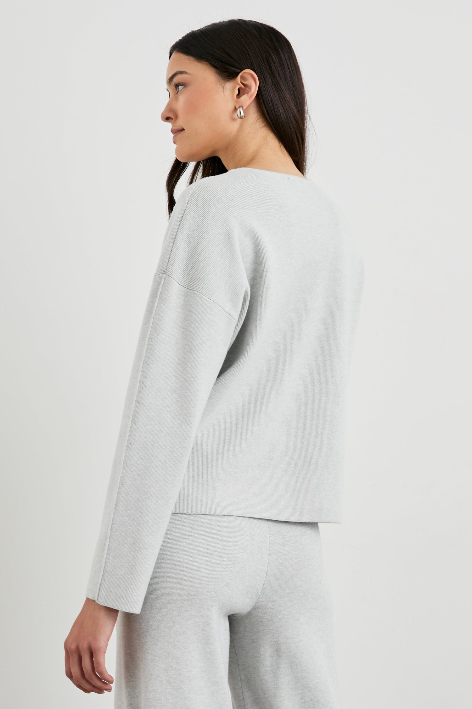 Hollyn Long-Sleeve Sweater with a V Neck and a Seam Down the Front Bodice and Sleeves in Light Heather Grey Colorway- Back View Featured on Model