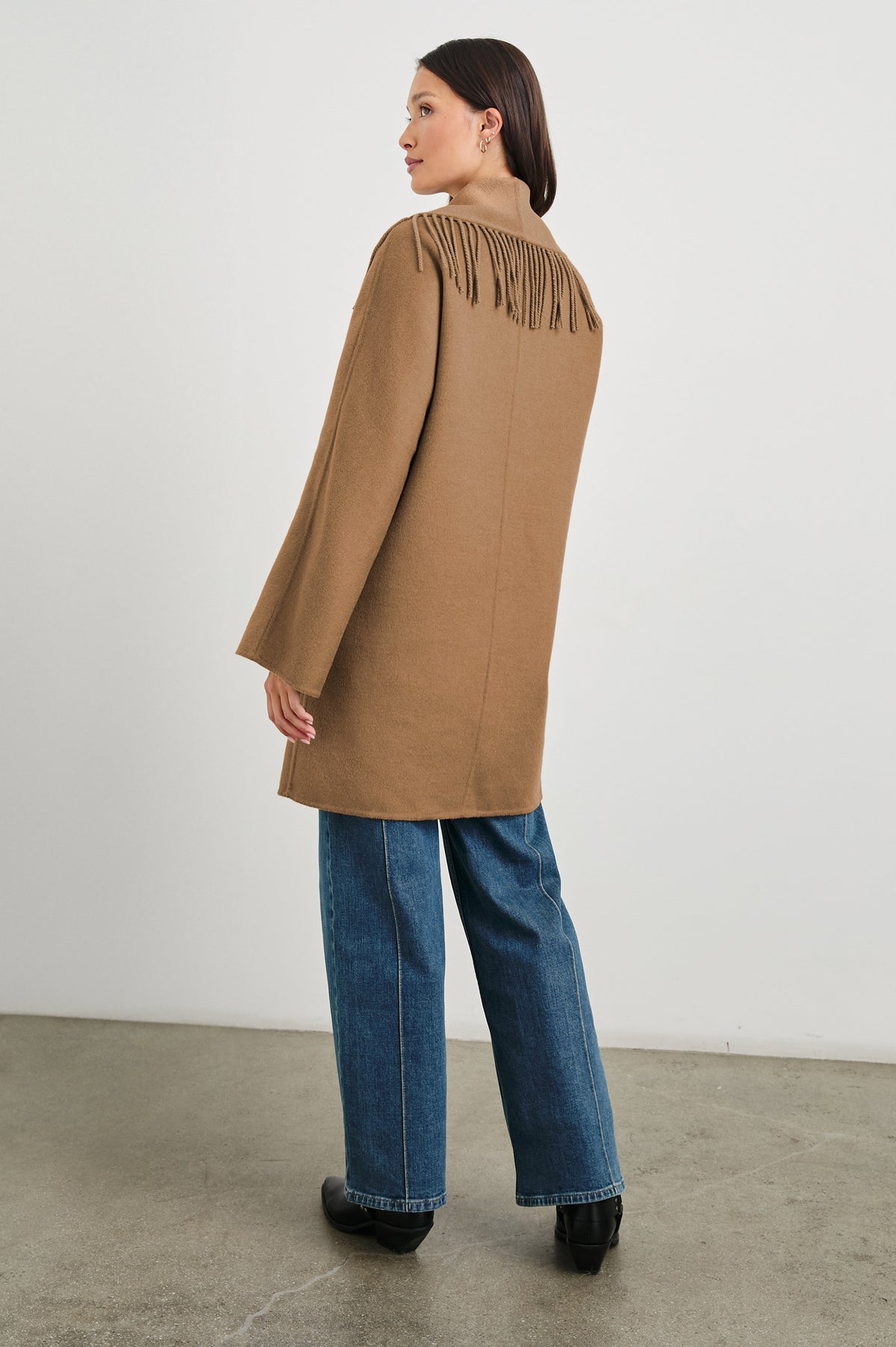 Hugo Double-Breasted, Mid-Thigh Length Coat with Button Closure, Wide Lapels, Two Front Patch Pockets and Fringe along the Lapels and Closure in Camel Colorway - Back Full Body View Featured on Model 