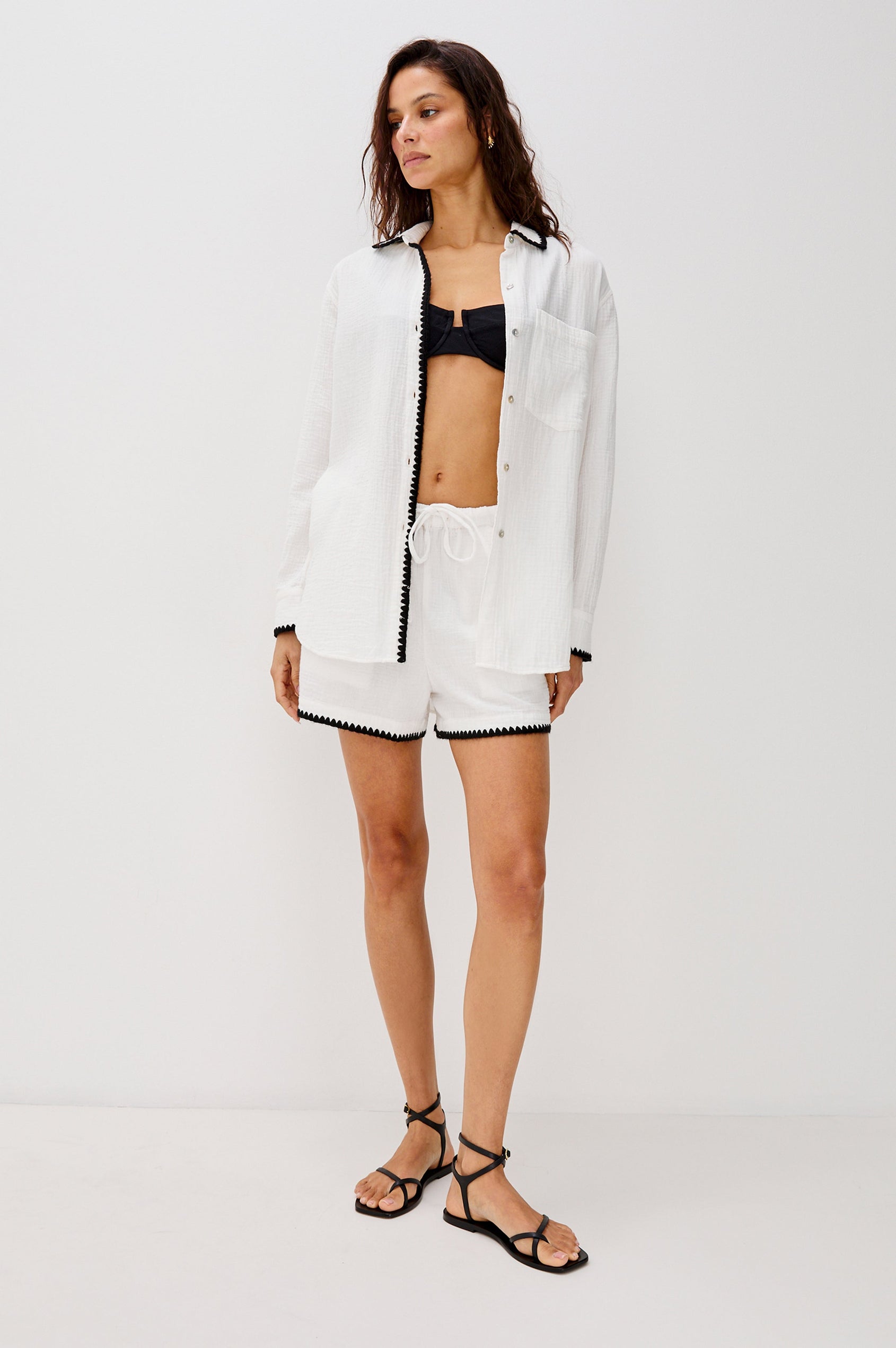 Idania Button Front Collared Shirt with Long Sleeves, Relaxed Fir and a Front Chest Pocket with a White Body in Black Blanket Stich Colorway. Full Body Front View Shown on Model.