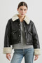 Imani Cropped Faux Leather Jacket with Silver-Toned Snap Closure, Two Front Snap Flap Pockets and Ivory Faux Shearling Lining, Collar and Cuffs in Black Ivory Colorway - Front View Featured on Model  