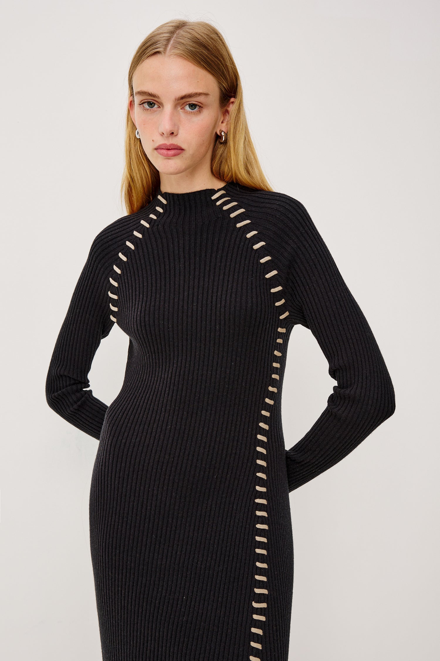 Imara Fitted Midi Dress in Ribbed Wool Silk Blend With Funnel Crew Neck, Long Sleves, and Side Slit in Black Oat Black Oatmeal Blanket Stitch Colorway - Upper Body Front View Featured on Model