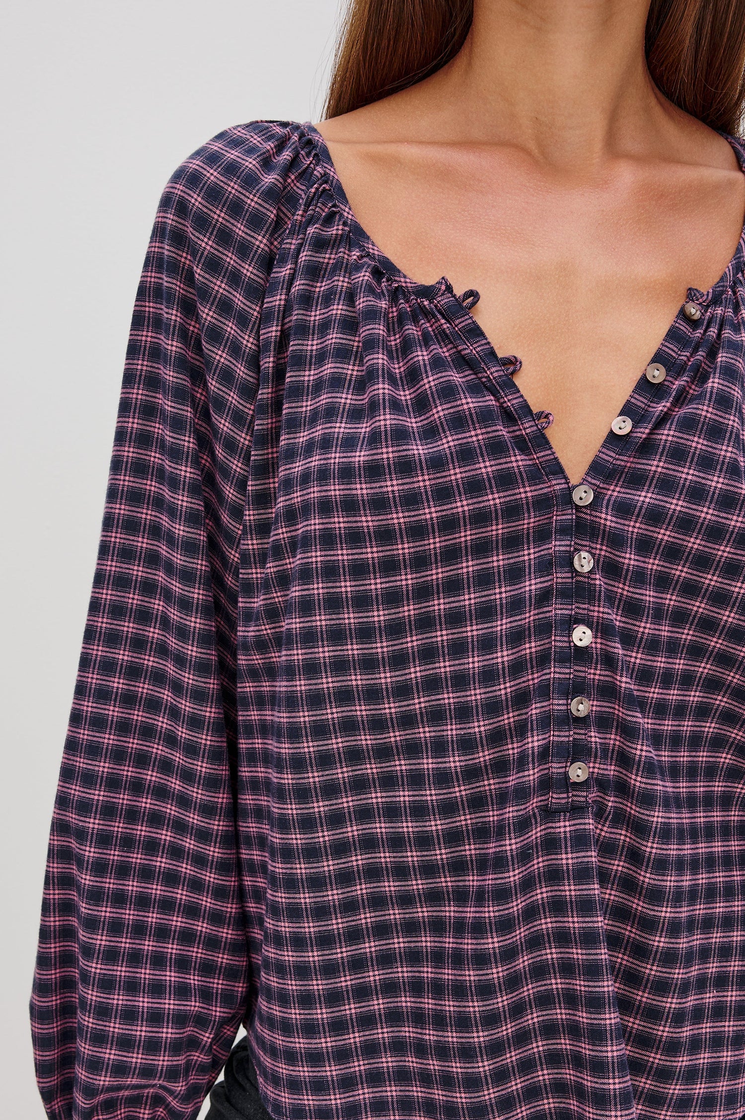 Indi Top with a V Neckline with a Button Placket, Pleating at Back Neckline and Elastic Cuffs in Rose Check Colorway - Close up front tucked in View Featured on Model