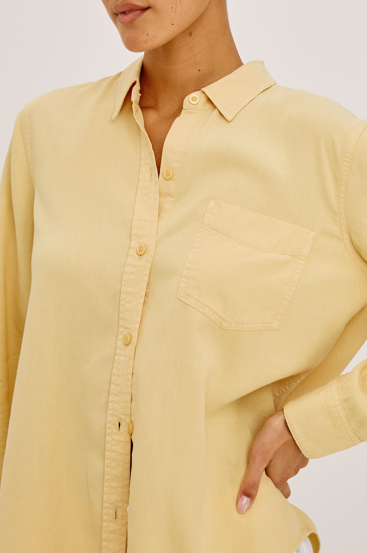 Ingrid Button-Up Shirt in TENCEL™Denim With Collar, Chest Patch Pocket, and Long Sleeves in Italian Straw Colorway - Upper Body Front View Featured on Model