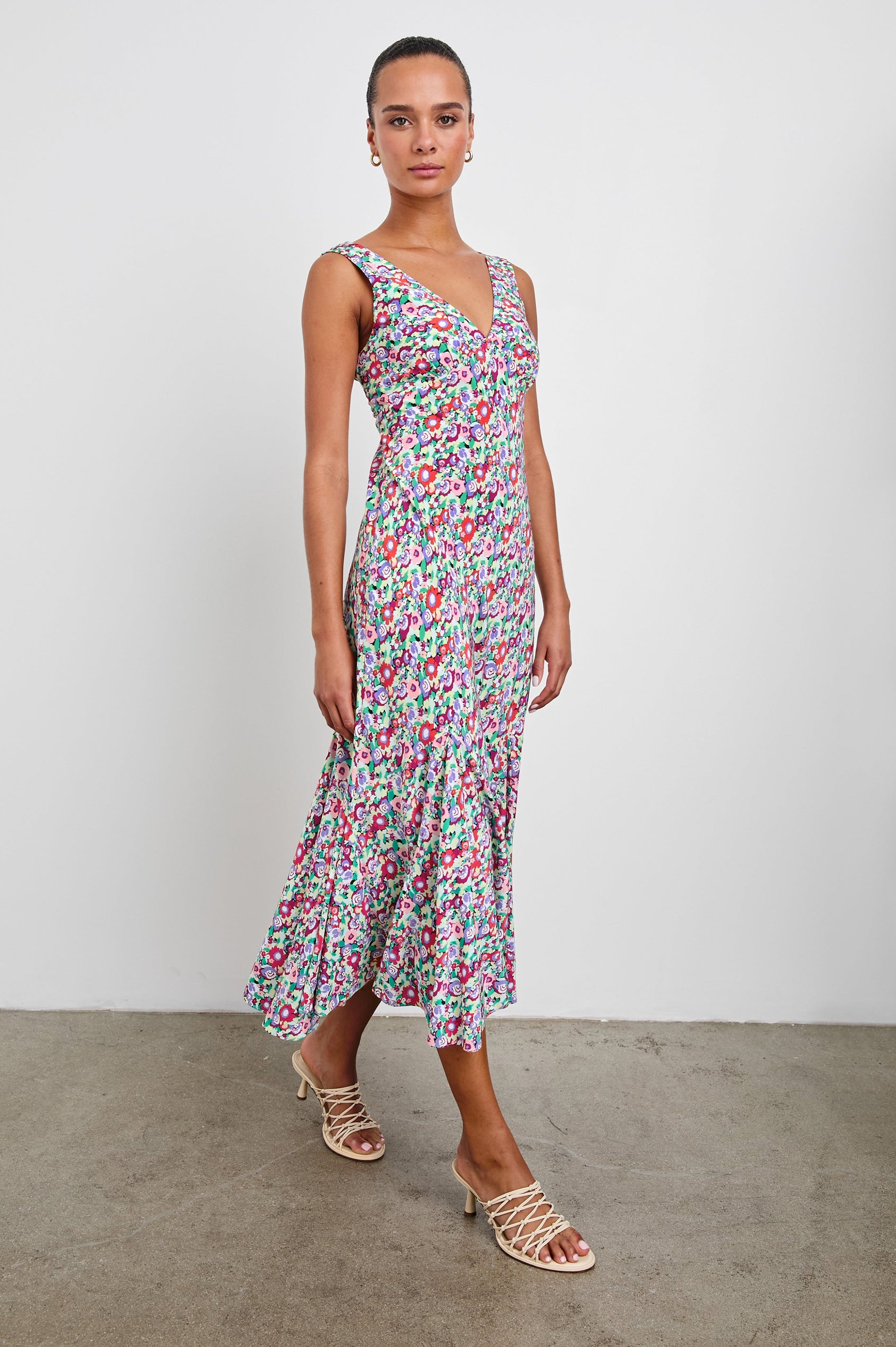 Irra Sleeveless Midi Dress with Wide Shoulder Straps, a Deep V Neck and an Empire Waist in Oversized Multi Floral Colorway, flowers in red, purple, pink and greens - Front Full Body View Featured on Model 
