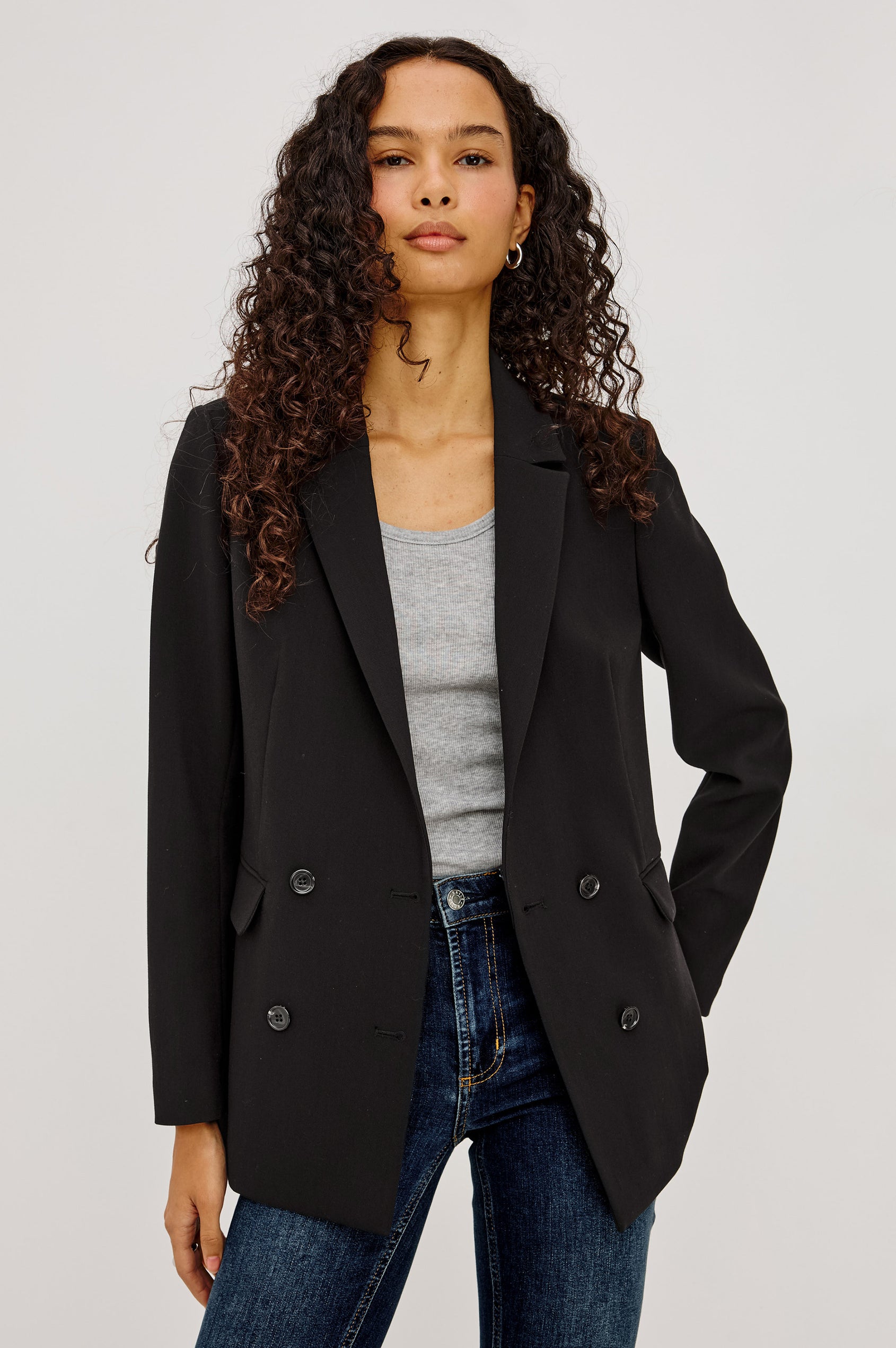 Jac Blazer in Wool Blend With Double-Breasted Design, Notched Lapels, Long Sleeves, Side Flap Pockets, and Fully Lined in Black Colorway - Upper Body Front View Featured on Model