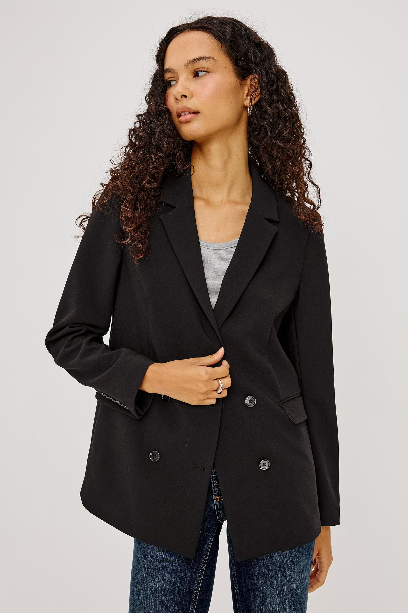 Jac Blazer in Wool Blend With Double-Breasted Design, Notched Lapels, Long Sleeves, Side Flap Pockets, and Fully Lined in Black Colorway - Upper Body Front View Featured on Model
