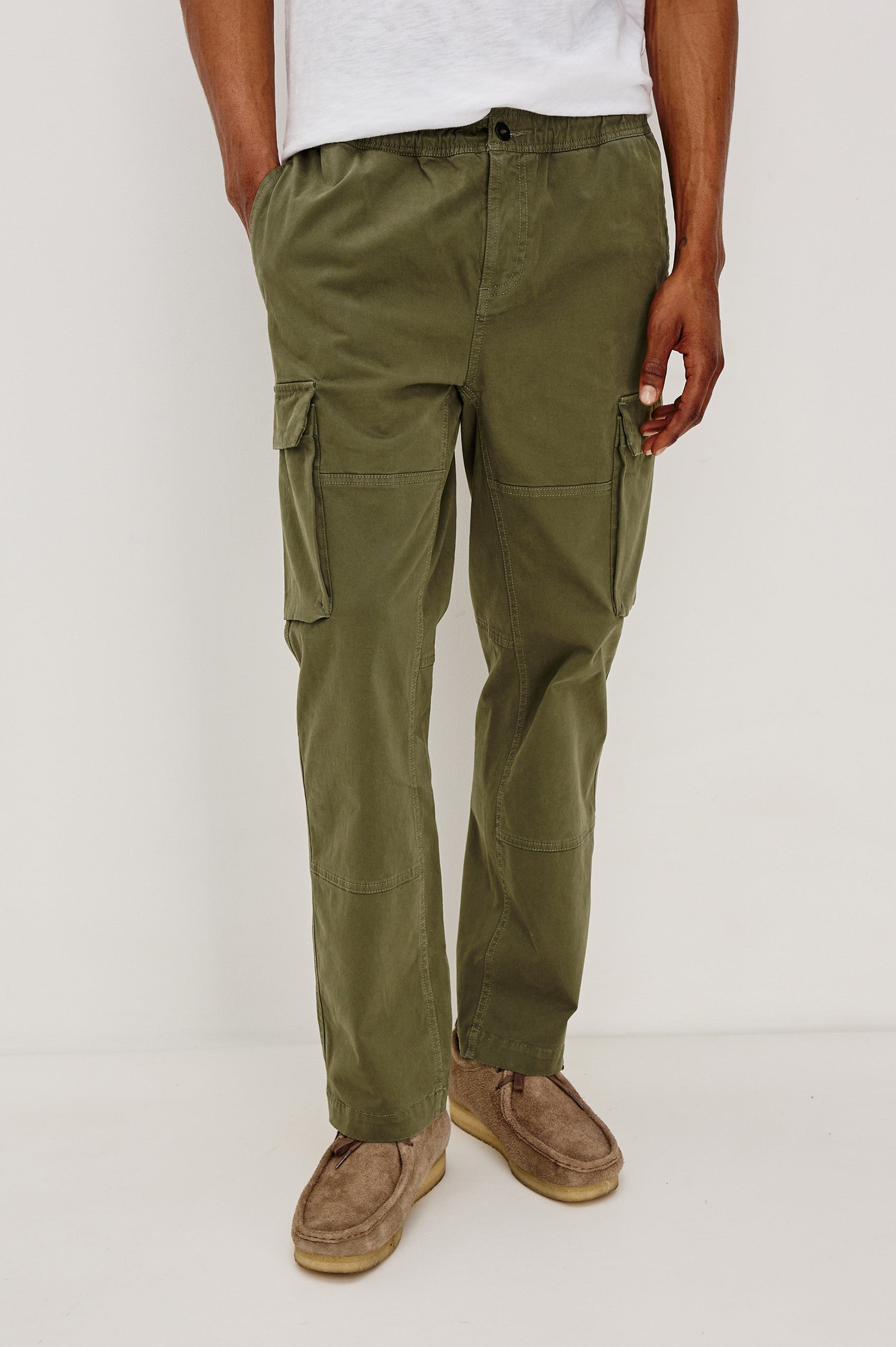 Jaiden Pants with an Elastic, Button Waist with Zip Fly, Two Front Pockets, Two Side Flap Pockets, and Two Back Flap Pockets in True Olive Colorway - Front View Featured on Model