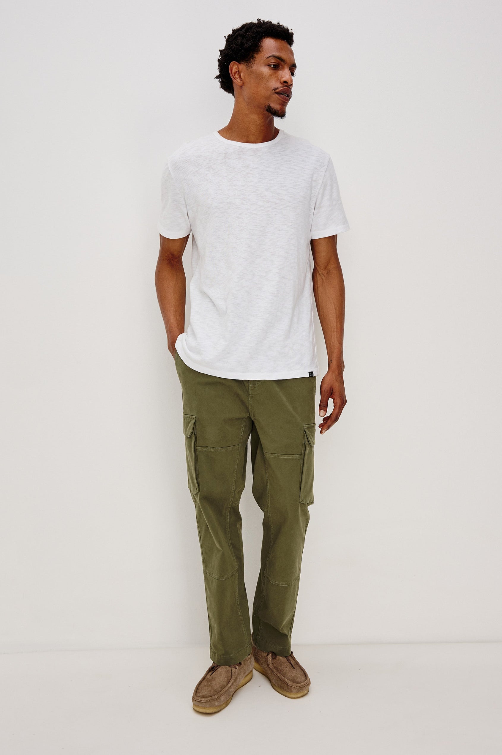 Jaiden Pants with an Elastic, Button Waist with Zip Fly, Two Front Pockets, Two Side Flap Pockets, and Two Back Flap Pockets in True Olive Colorway - Full Body Front View Featured on Model