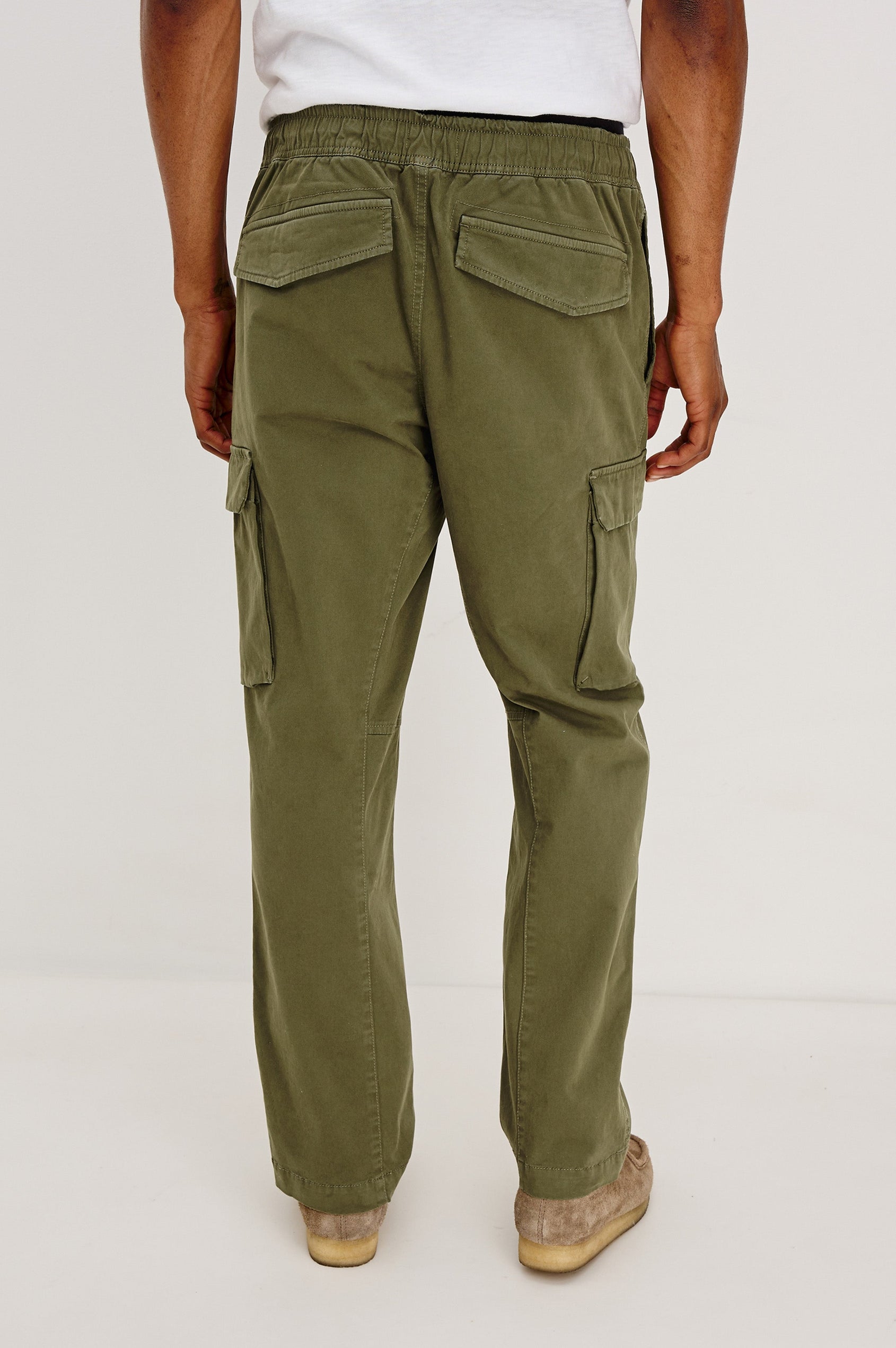 Jaiden Pants with an Elastic, Button Waist with Zip Fly, Two Front Pockets, Two Side Flap Pockets, and Two Back Flap Pockets in True Olive Colorway - Back View Featured on Model