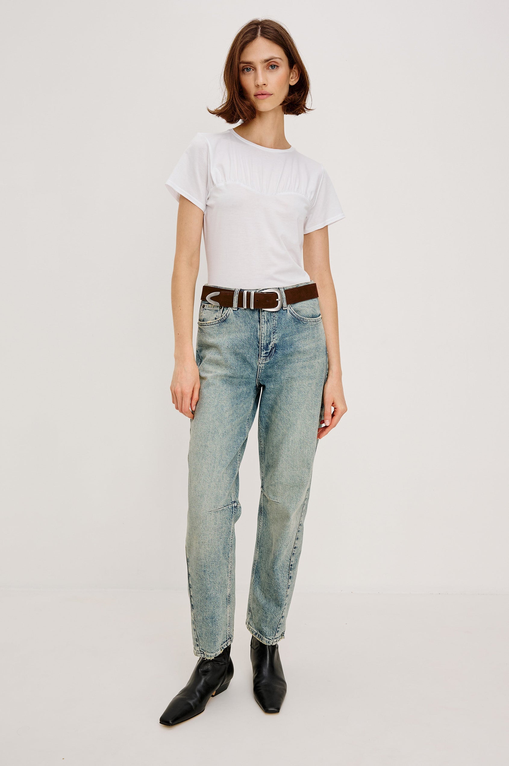Janis short-sleeve cotton t-shirt with a sweetheart neckline and gathered, shirred detailing at the chest in White Colorway - full body front view featured on model with shirt tucked in and styled with a western belt.