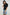 Jewel Top with Elbow-Length Sleeves, a Six Button Placket Creating a V Neck, Elasticized Cuffs and Light Ruching on Sleeves in Black Colorway - Front View Featured on Model