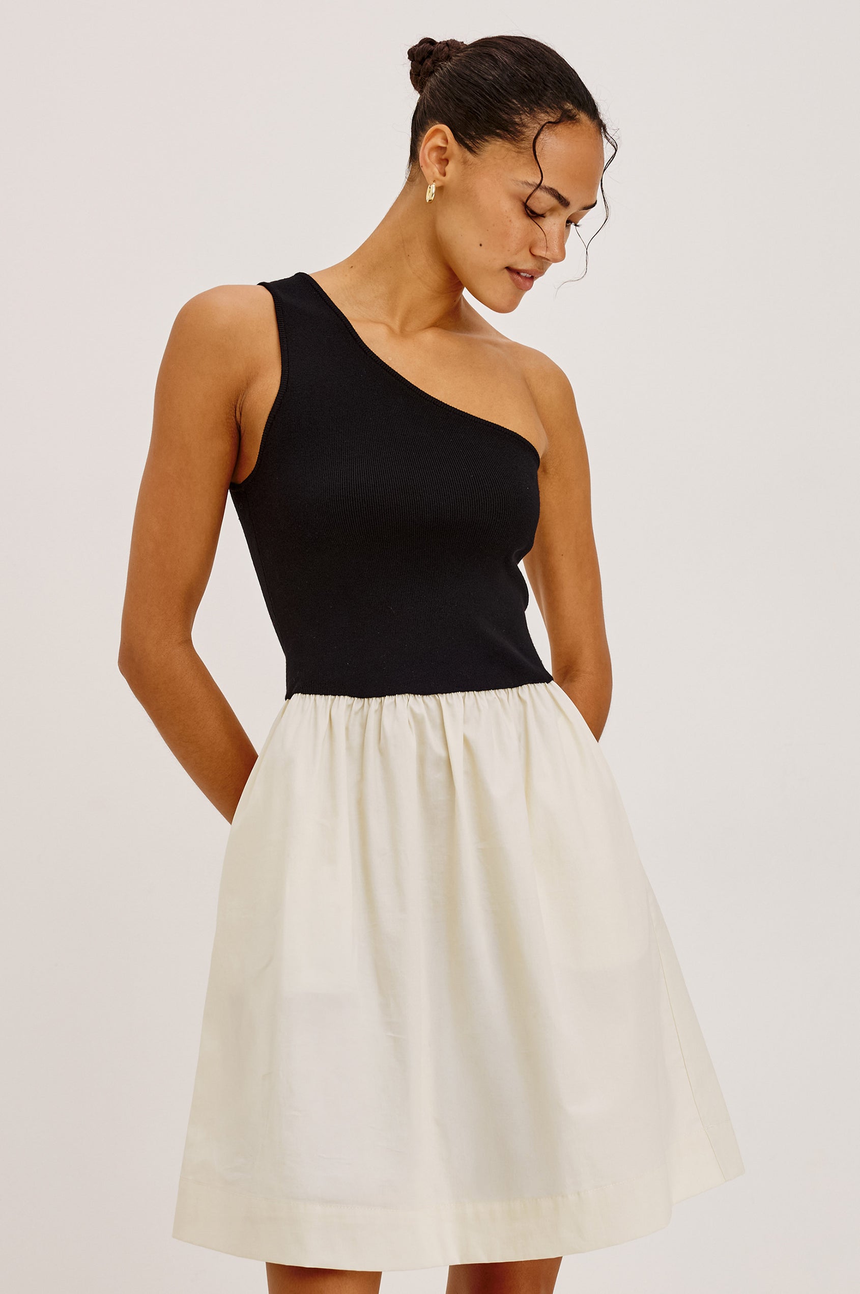 Joanne Mini Dress With One-Shoulder Neckline, Soft Jersey Bodice, Contrast Dropwaist Cotton Poplin Skirt, and Side Pockets in Black Ivory Colorway - Upper Body Front View Featured on Model