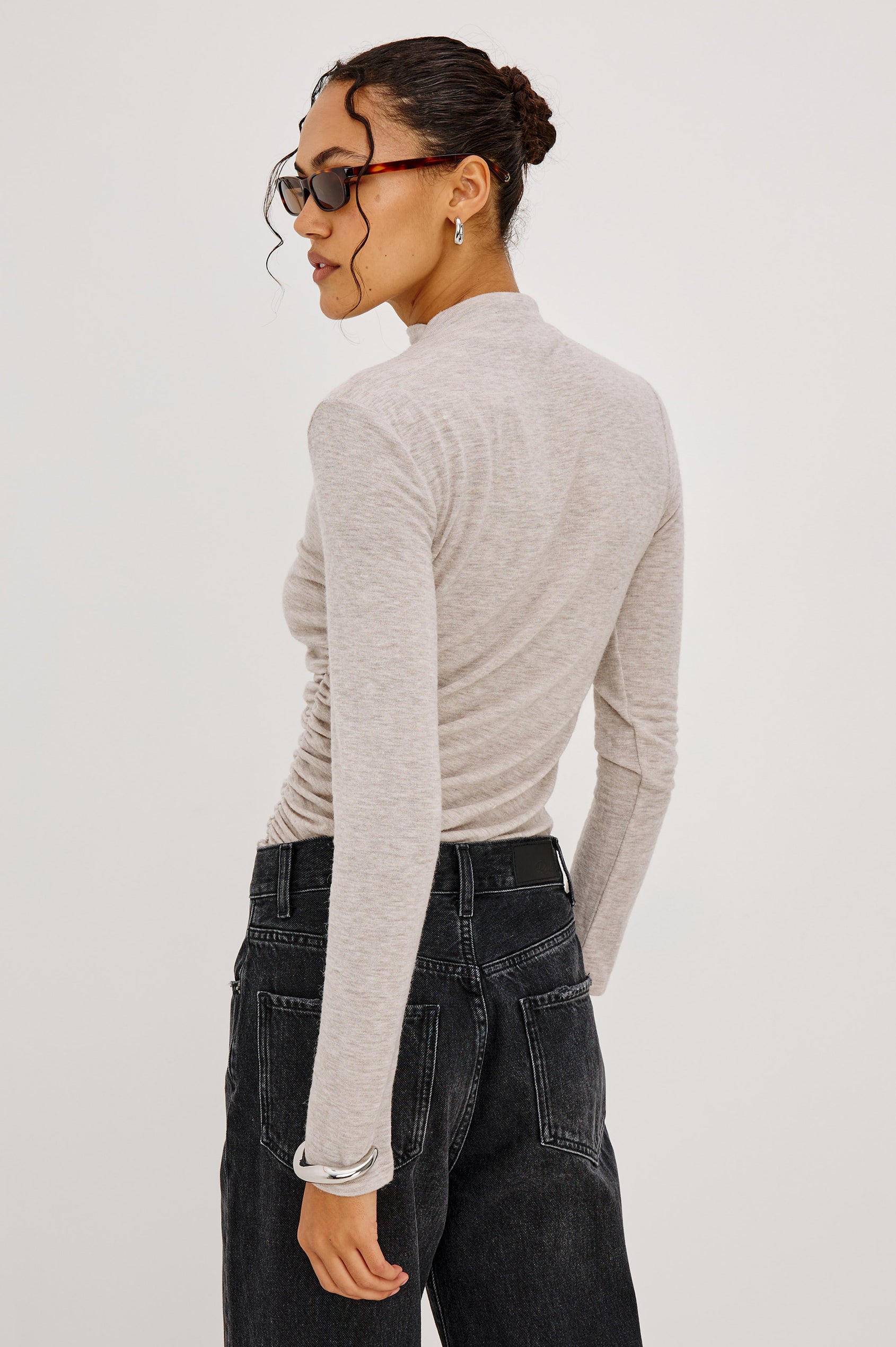 Joelle Top Fitted in Jersey With High Funnel Neckl, Long Sleeves, and Asymmetric Shoulder Shirring in Heather Oatmeal Colorway - Upper Body Back View Featured on Model