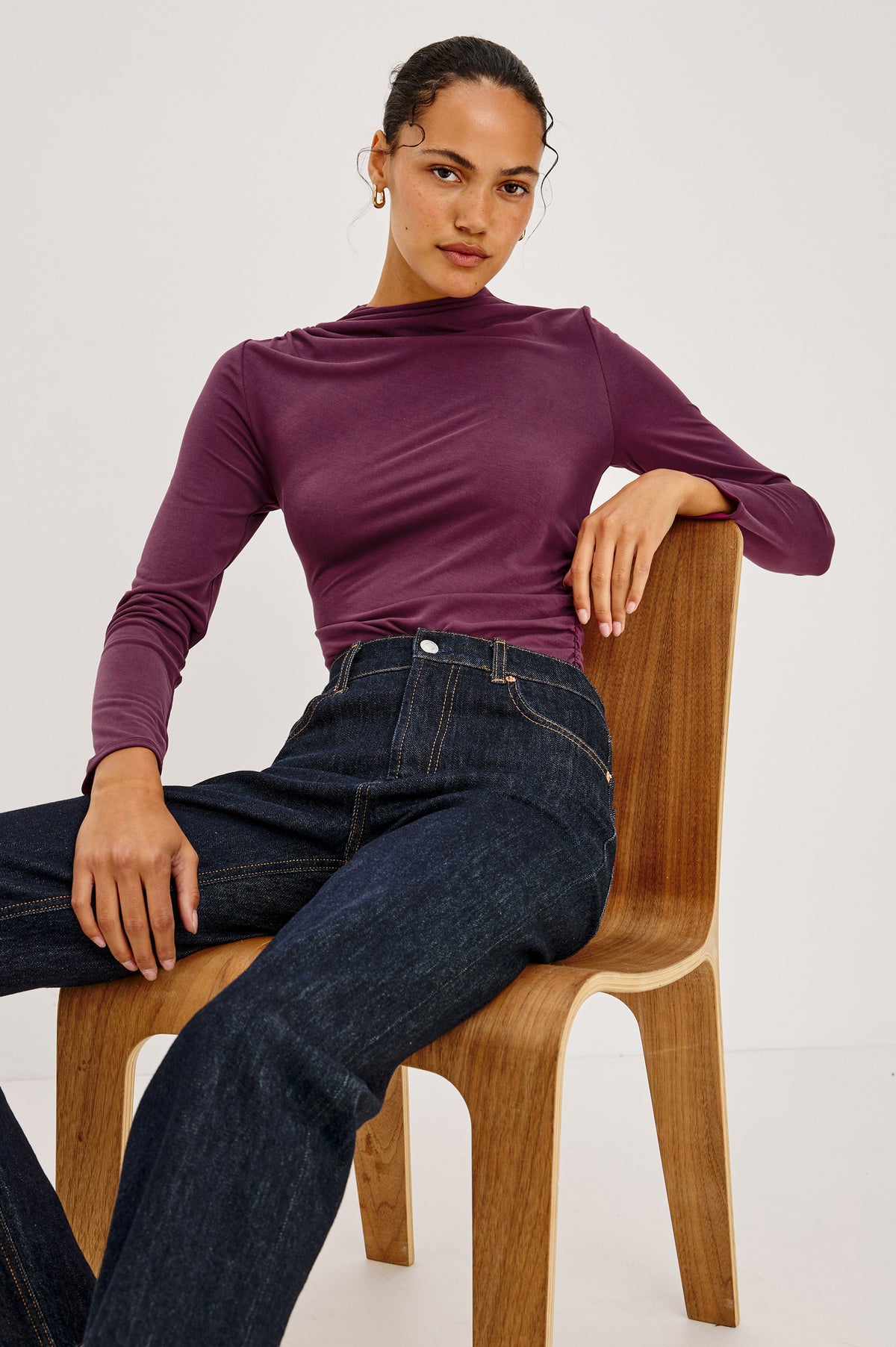 Joelle Top in Brushed Jersey With Draped Mock Neck, Shirring at Shoulder and Side, Long Sleeves, and Fitted Silhouette in Wine Colorway - Front Crop View Featured on Model Stitting.