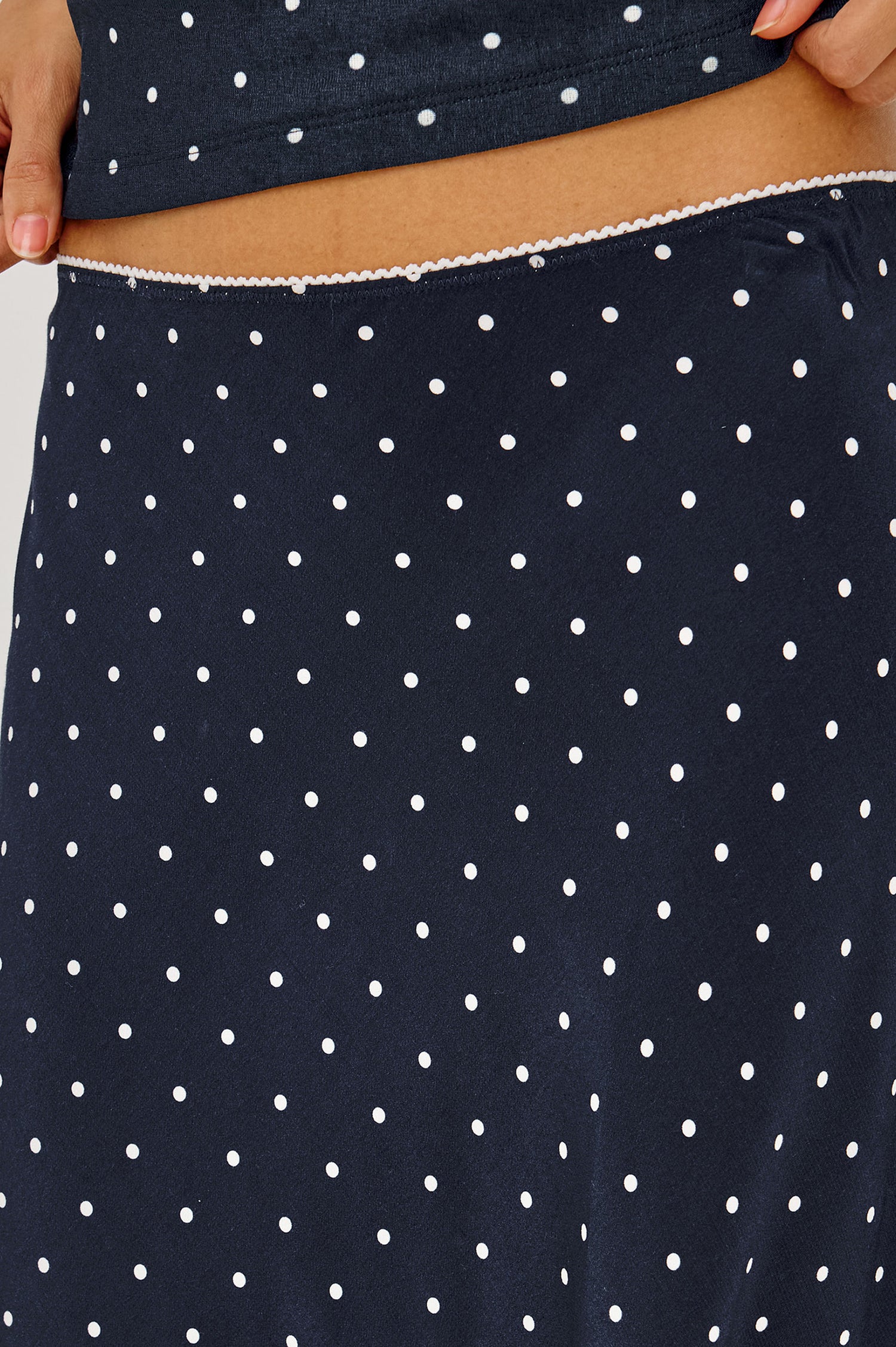 Jolene Midi Skirt in Rayon Crepe With Scalloped Elastic Waistband in Navy Polka Dots Colorway - Lower Body Front View Featured on Model