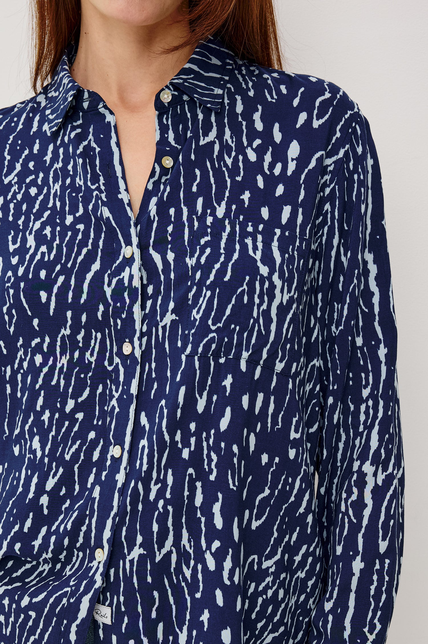Josephine Button-Up Shirt in Rayon With Collar, Front Buttons, Chest Pockets, and Long Sleeves in Dark Navy Lynx Colorway - Front Close Up View Featured on Model