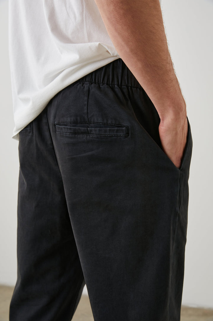  Julian Pants with an Elastic Waist, Two Front Pockets and Two Back Welt Pockets in Washed Black Colorway - Back View Featured on Model 