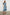 Kahlo Short-Sleeve Midi Dress with Snaps Down the Front, a Waist Tie, a Chest Patch Pocket and a Pleated Hem in Mid Blue Colorway - Front Full Body View Featured on Model