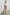 Karysa Short-Sleeve Top with Flutter Sleeves, a Deep V Neck with a Drawstring, Ruching at the Back Collar, and a Vertical Front Center Seam in White Colorway - Front Tucked View Featured on Model 