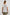 Karysa Short-Sleeve Top with Flutter Sleeves, a Deep V Neck with a Drawstring, Ruching at the Back Collar, and a Vertical Front Center Seam in White Colorway - Back View Featured on Model 