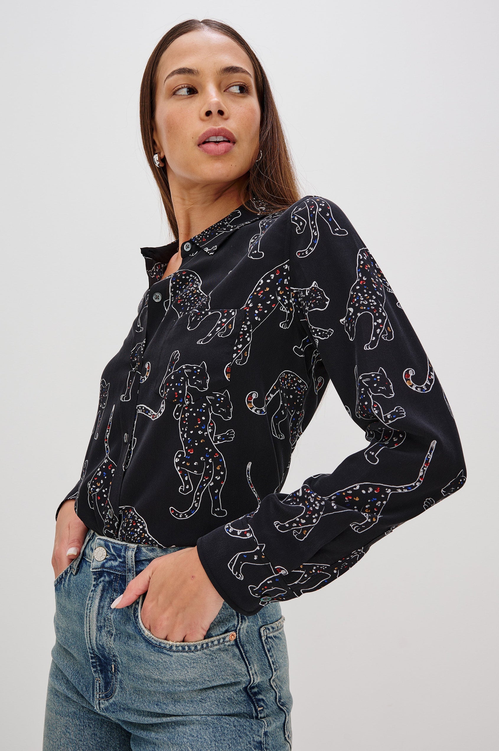 Washed silk button-down shirt in ivory with a horse print. The shirt has a soft drape and classic collar for a polished look. Side View on Model.