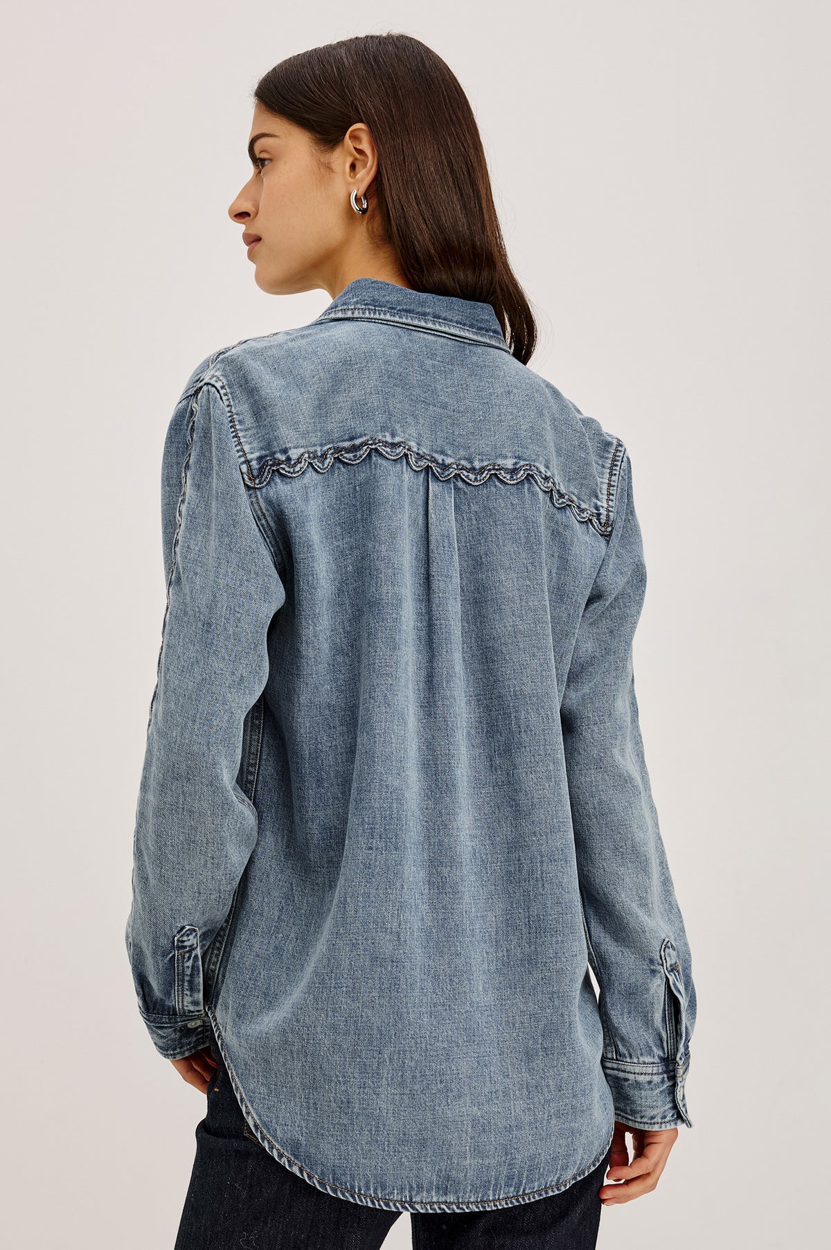 Kellan Shirt in TENCEL™ Denim With Relaxed Fit, Chest Patch Pocket, Zig-Zag Trim at Long Sleeves, Front Buttons, and Shirttail Hem in Mid Blue Colorway - Upper Body Back View Featured on Model.