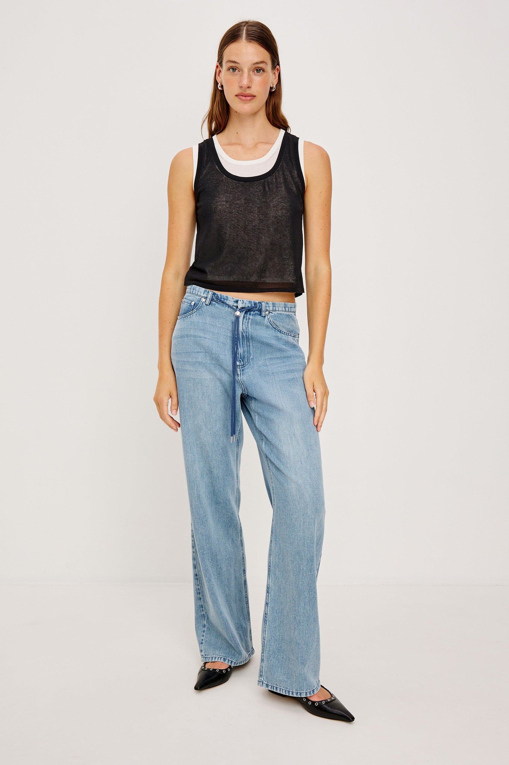 The Kelly is a semi sheer double layered scoop neck tank top, black on top and ivory as under layer. Front full body view featured on model.