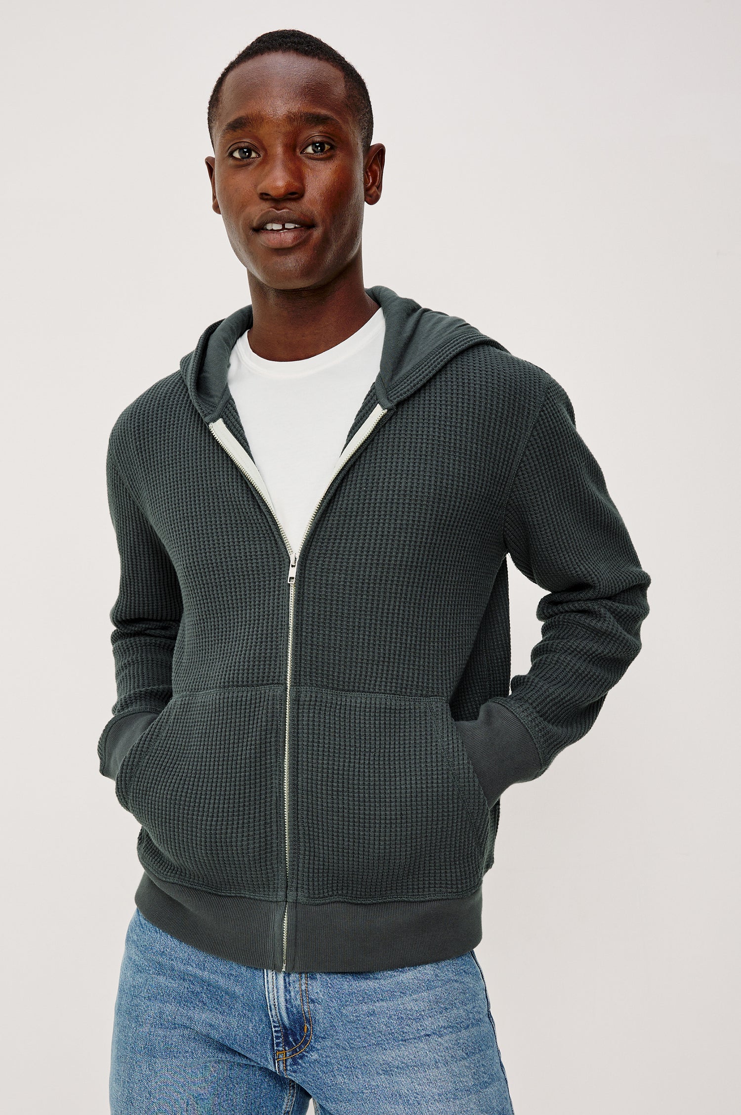Kenton Waffle Knit Zip Front Hoodie Sweatshirt With Front Patch Pockets, Long Sleeves, and Ribbed Cuffs in Ink Colorway - Upper Body Front View Featured on Model