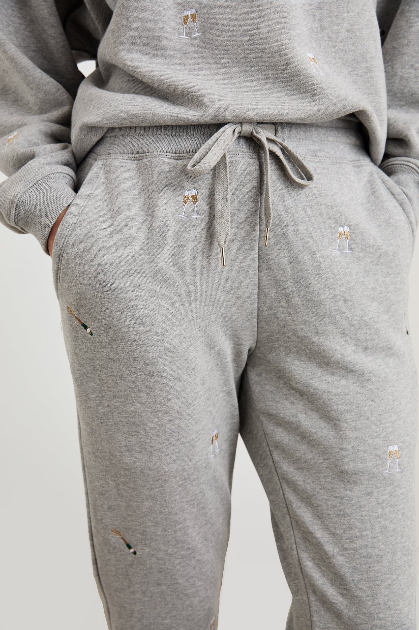 Kingston Pants with Elastic Cuffs and Waist with Drawcord in Champagne Embroidery Colorway, Champagne Glasses on Grey - Front View Featured on Model