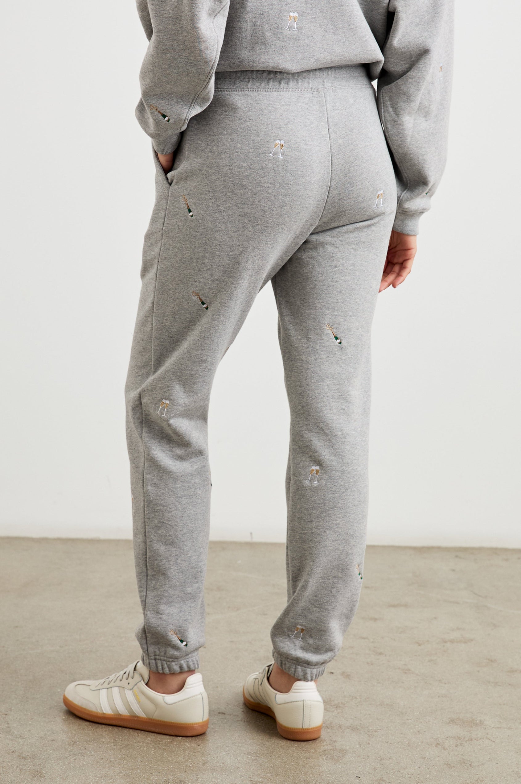 Kingston Pants with Elastic Cuffs and Waist with Drawcord in Champagne Embroidery Colorway, Champagne Glasses on Grey - Back View Featured on Model