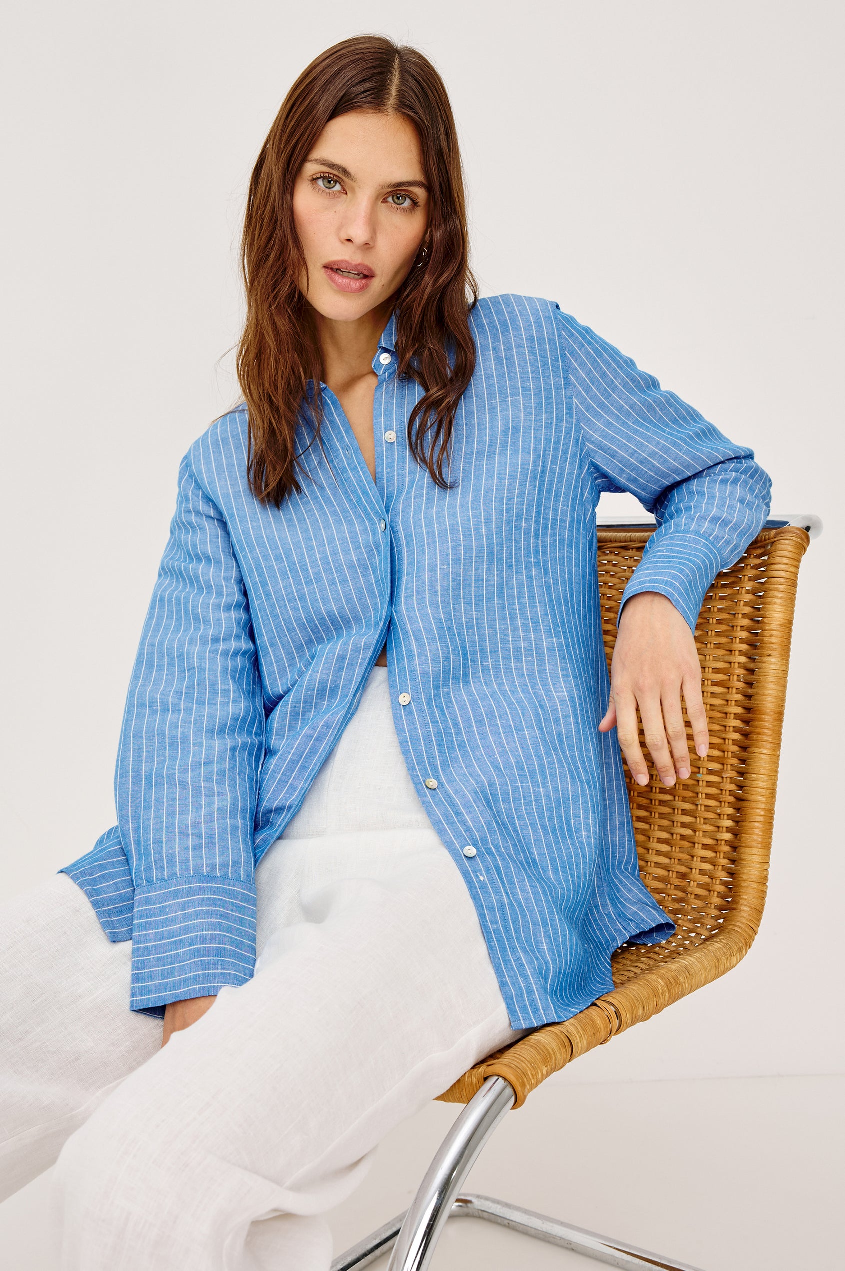 Knox Button-Up Shirt in Linen Viscose With Collar, Front Buttons, Long Sleeves, and Relaxed Fit in Avalon Stripe Colorway - Upper Body Front View Featured on Model Sitting