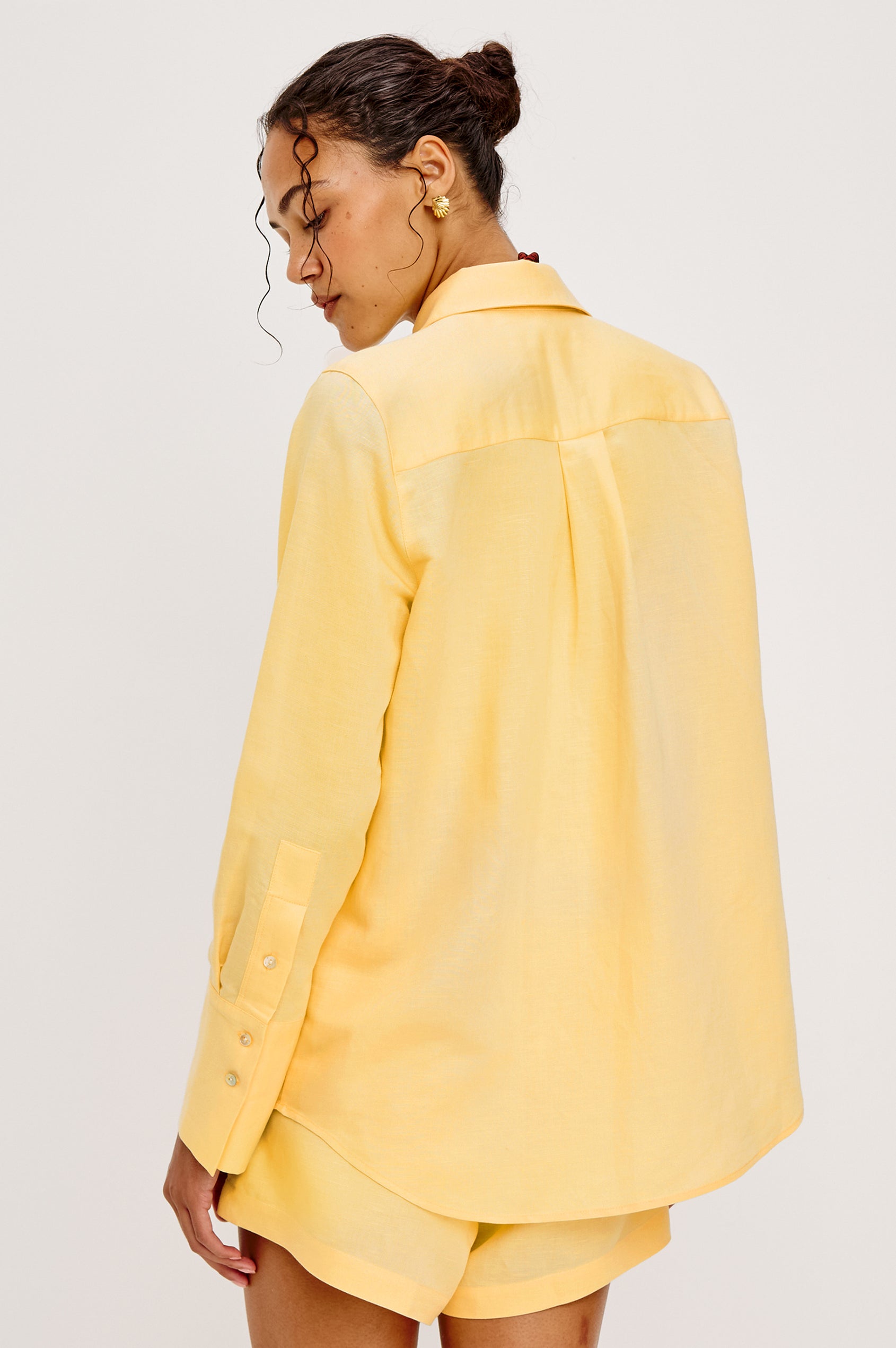 Knox Button-Up Shirt in Linen Viscose With Collar, Front Buttons, Long Sleeves, and Relaxed Fit in Sunshine Colorway - Upper Body Back View Featured on Model