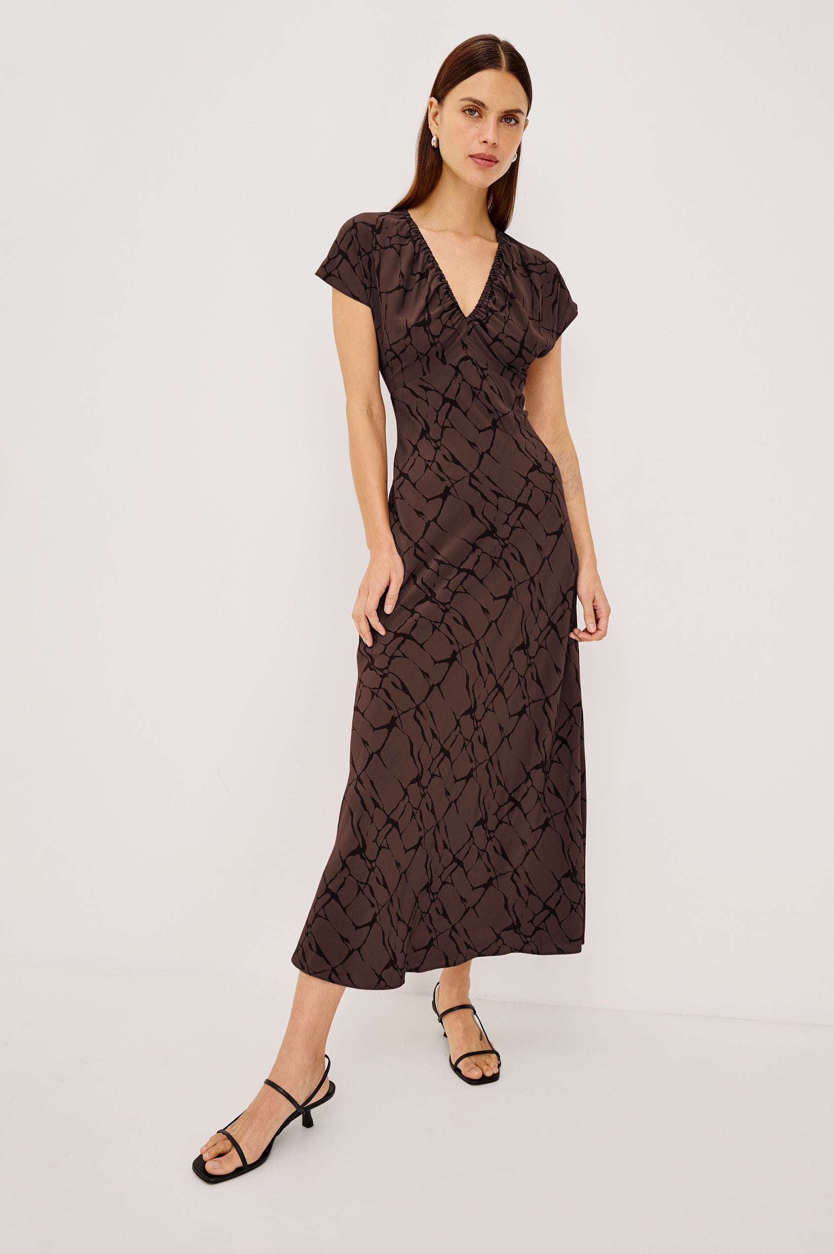 Kourt Midi Dress in Lightweight Crepe With Elastic V-Neckline, Empire Waist, Extended Cap Sleeves, and Hidden Side Zip in Brown Obsidian Colorway - Full Body Front View Featured on Model