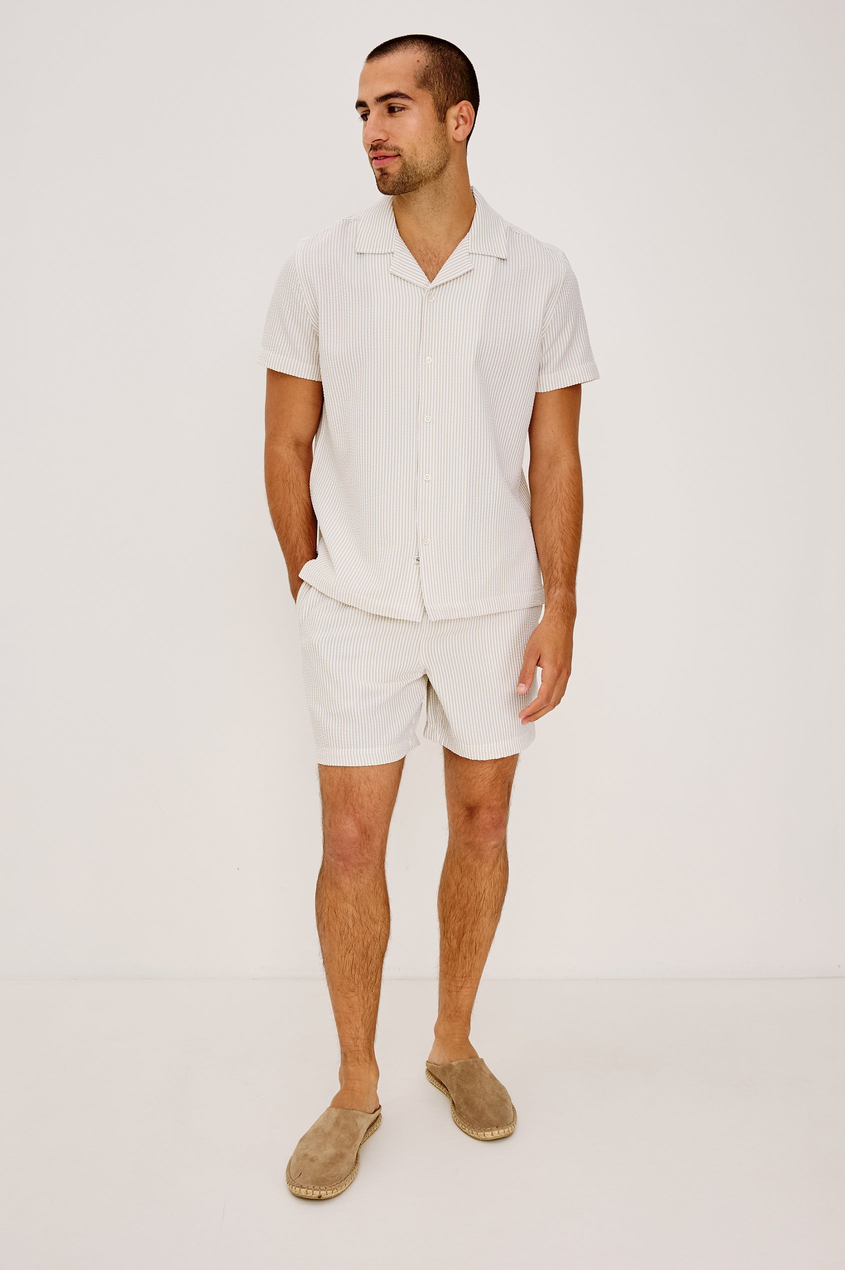 La Brea Mid-Length Swim Shorts With Adjustable Waist Drawstring Ties and Side Pockets in Khaki White Seersucker Colorway - Full Body Front View Featured on Model